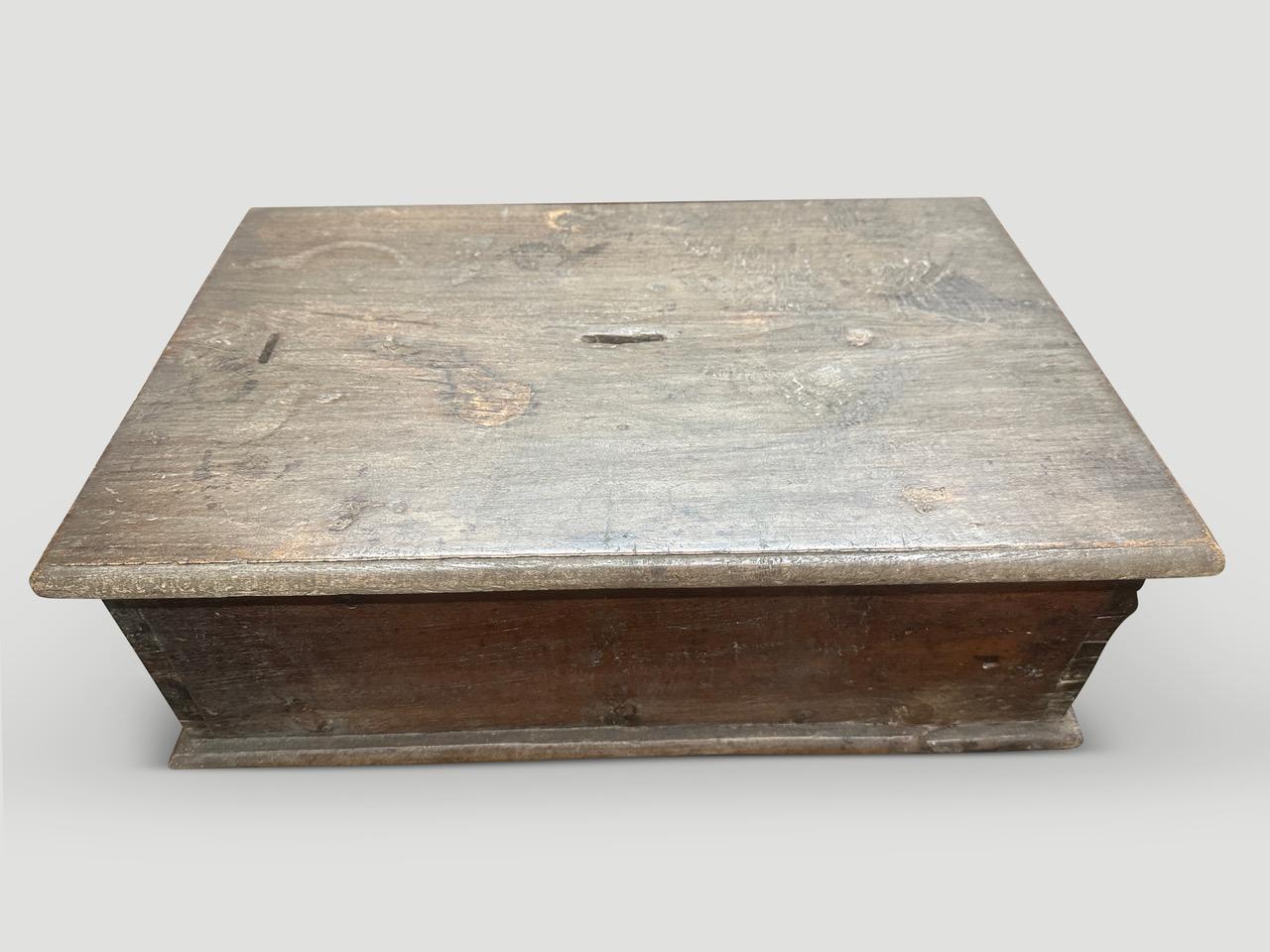 Antique wood box originally used for storing valuables. There is no key however the original hardware is intact. Lovely patina and markings throughout celebrating time and loving use on this beautiful teak box. Circa 1950.

This antique box was