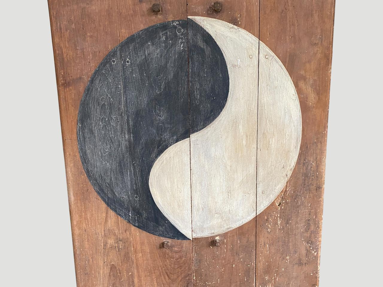 Impressive teak wood doors with original hardware. This beautiful door could also be made into a coffee table, used as a head board or hung as a piece of art. The circle meaning is the Yin and the Yang. The black colour is Yin the darkness and white