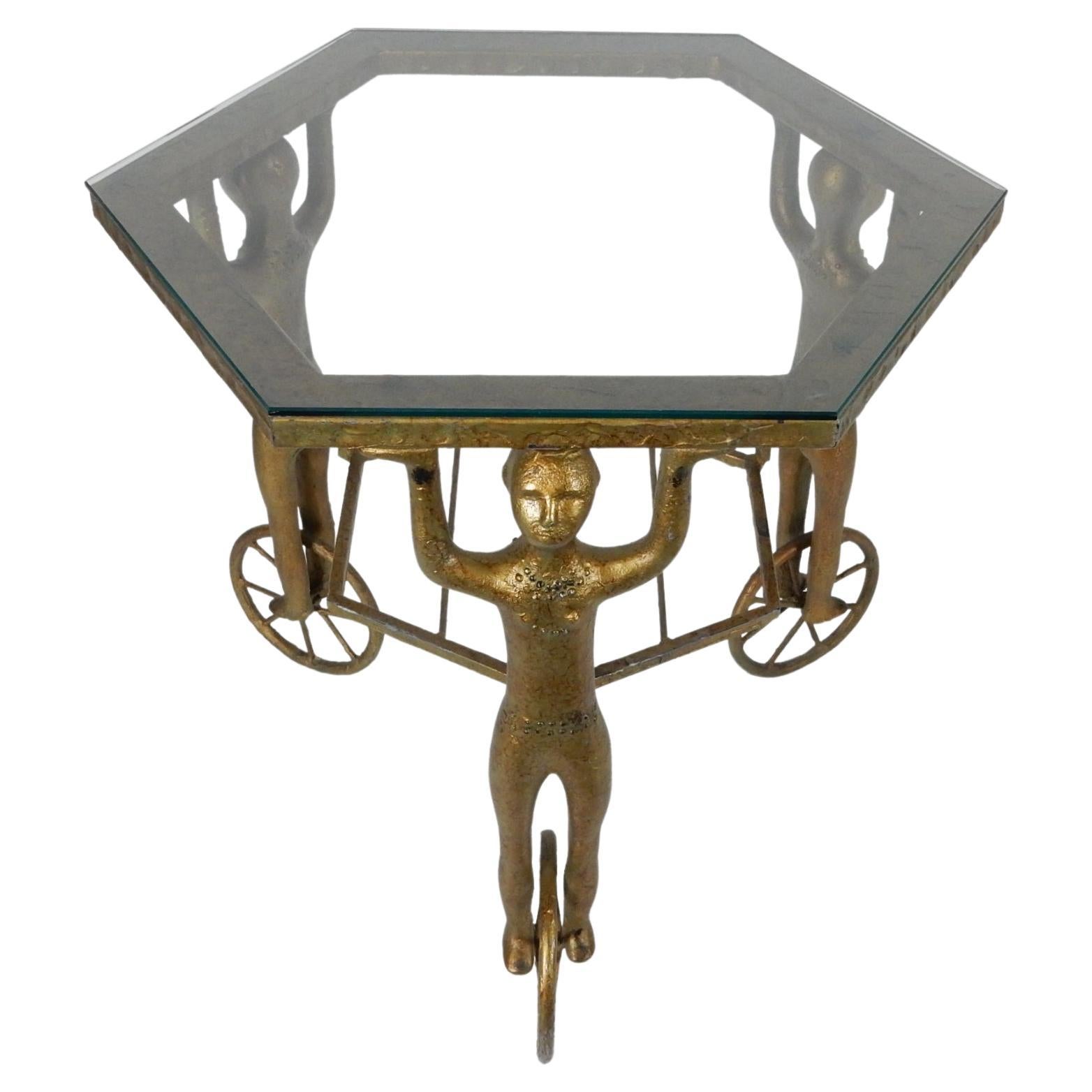 Incredible mid 20th century Gueridon table cast in iron with gold enamel finish.
Legs are androgynous figures standing on wheels in the style of Alberto Giacometti.
Not signed or marked by designer. Possibly a one-off cast studio piece.
We could not