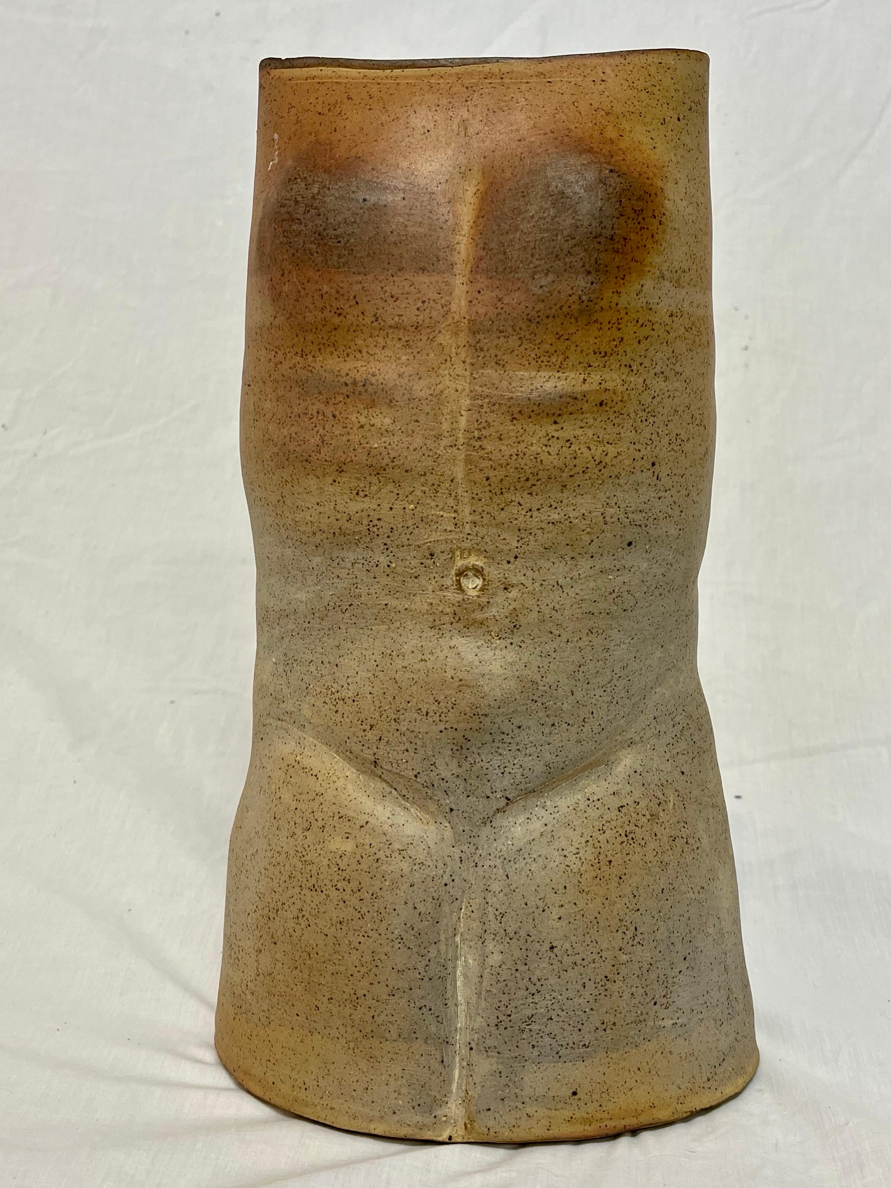 An impressive androgynous nude torso sculpture presented as a vase or vessel. The idea that this figurative representation of the human form is given as a vase allows the viewer to place or fill the beauty they have within the sculpture, within the