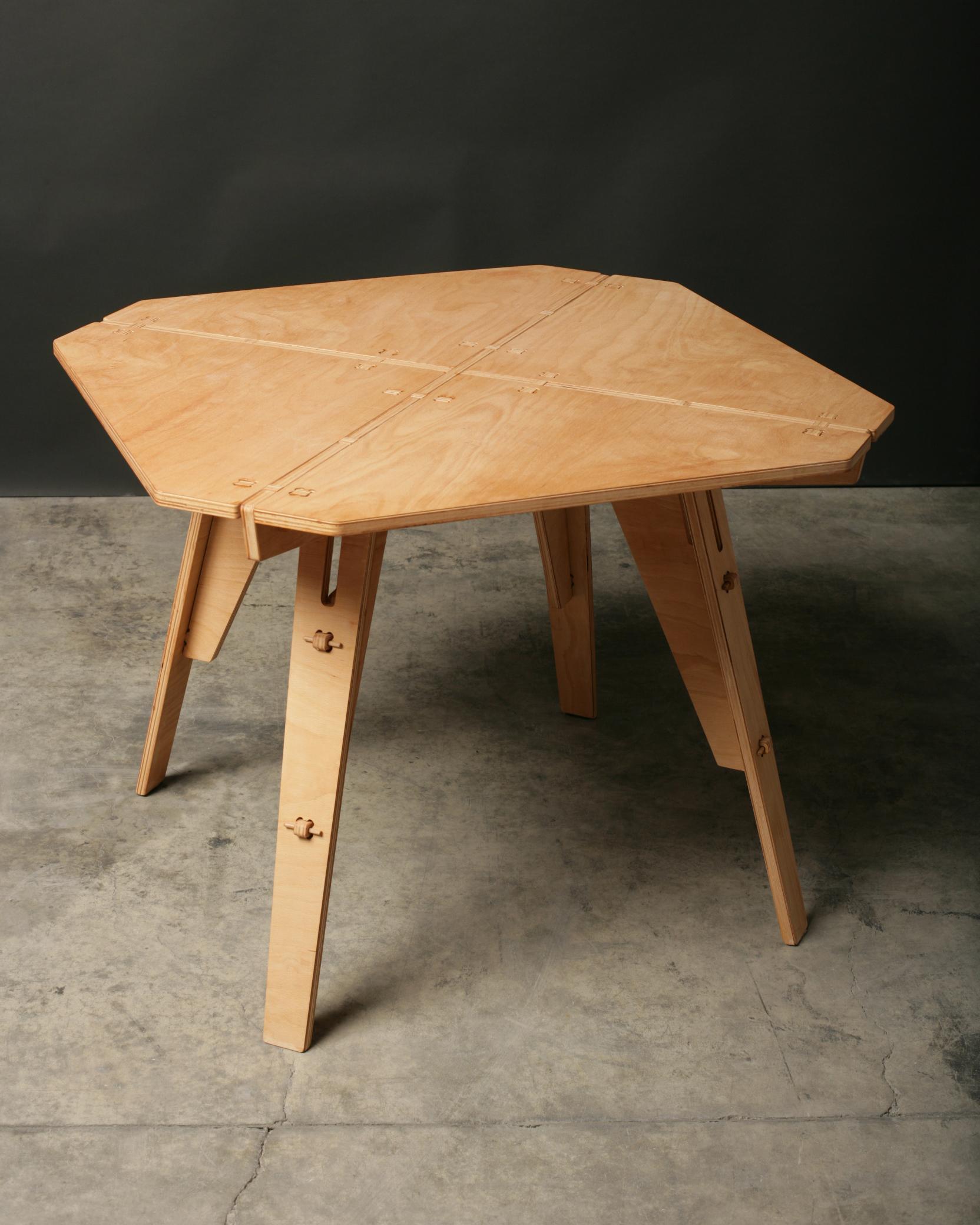 The table is designed by the Bulgarian sculptor Konstantin Achkov and features exclusive engineering combined with traditional wooden joints. The origami puzzle structure assembles into a solid, made to last, natural and ecofriendly dining