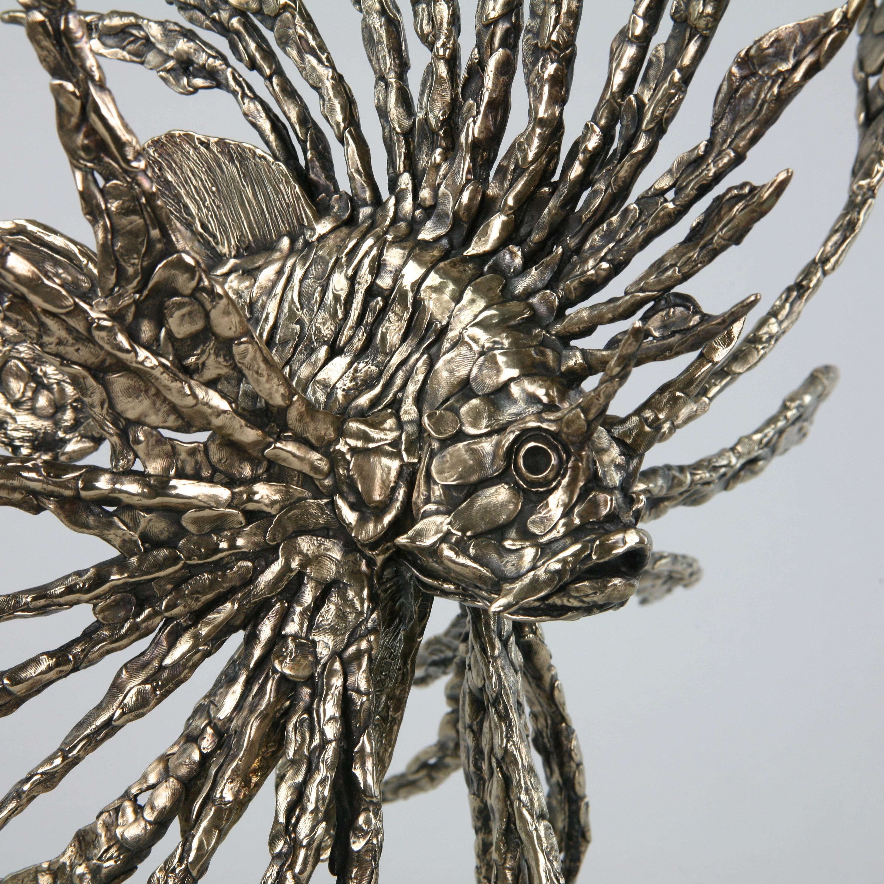 This contemporary marine sculpture by Andrzej Szymczyk depicts a Devil Firefish and is expertly cast in bronze. The free standing piece is finished with a golden hue coating, a hue reminiscent of the whimsicality of the natural ocean environment,
