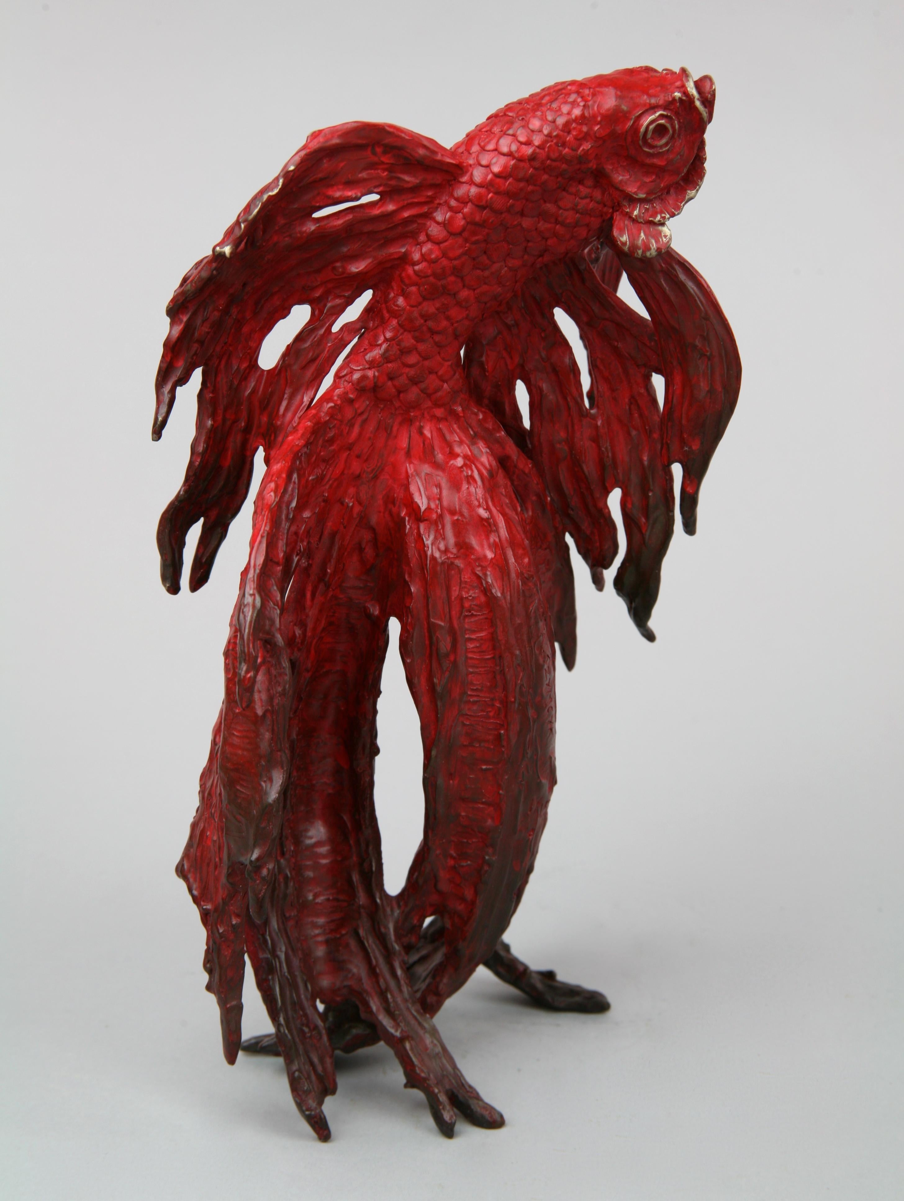 This contemporary marine sculpture by Andrzej Szymczyk depicts a Coral Fish and is expertly cast in bronze. The free standing piece is finished with a striking red coating, a hue reminiscent of its natural ocean environment, and features