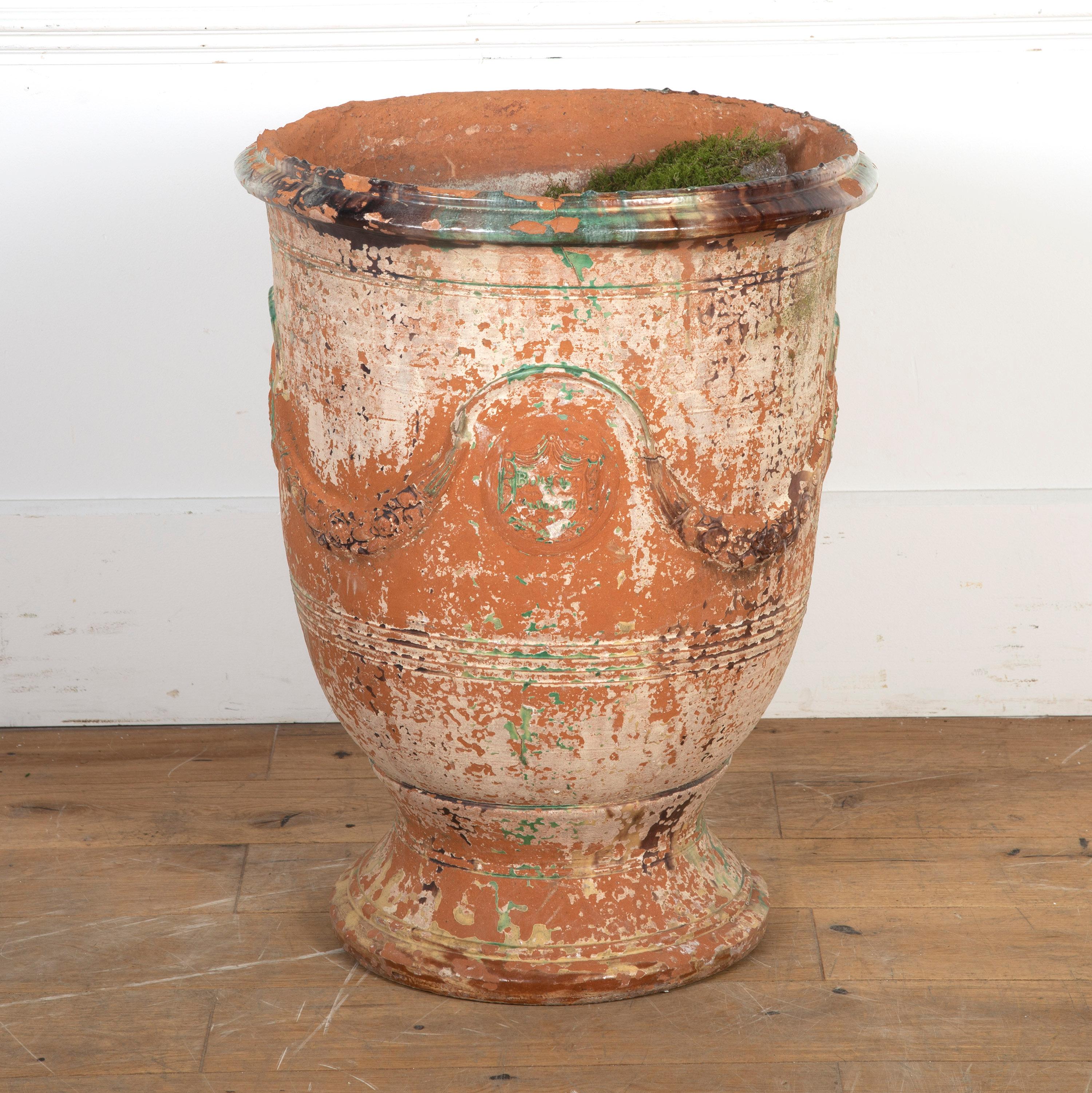 Charming French Anduze vase.

Dating from the 19th Century and of French origin, this terracotta Anduze vase was manufactured by Boisset. It has a moulded rim whilst the main body is decorated with swags and is supported on a spreading circular