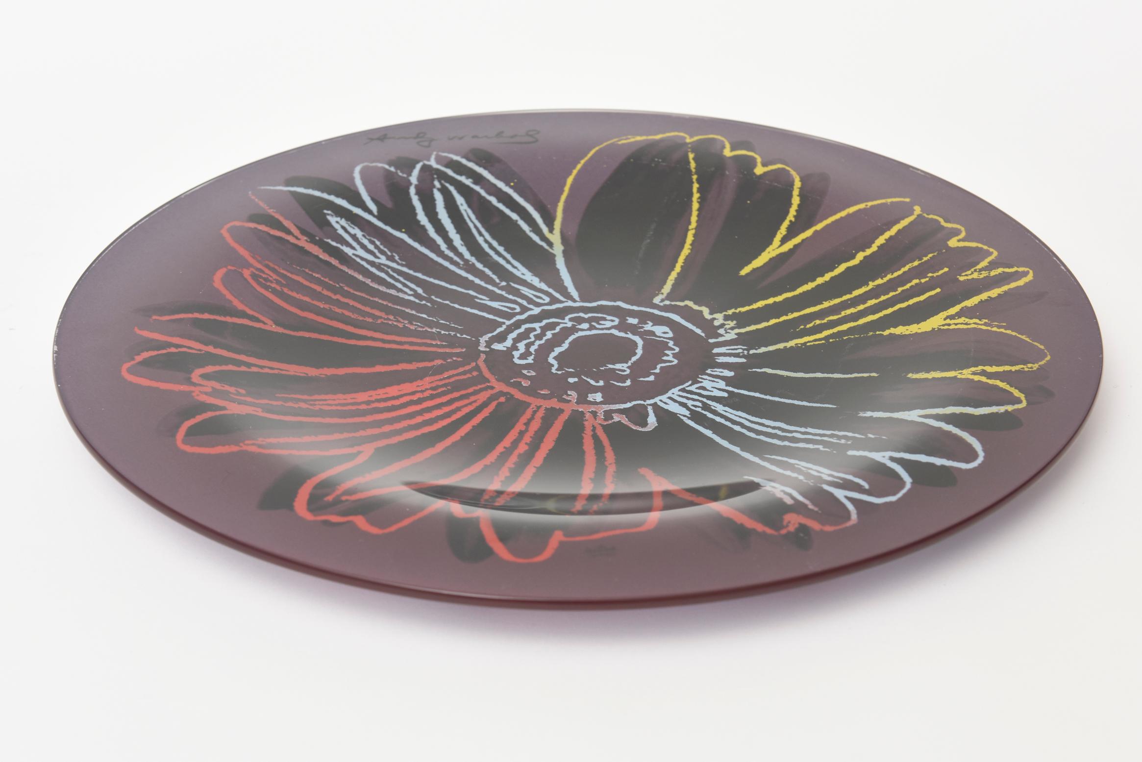 This iconic blown glass flower plate designed after Andy Warhol and produced by Rosenthal is from the 1980s. It came in a few different color waves. This is the last one we have remaining. It can be used for serving or just as decor. Tres chic! It