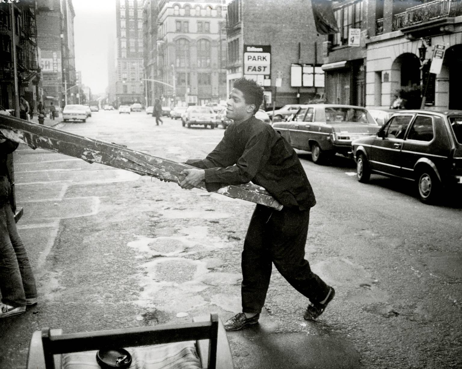 Andy Warhol Portrait Photograph - Jean-Michel Basquiat Carrying a ladder in Soho
