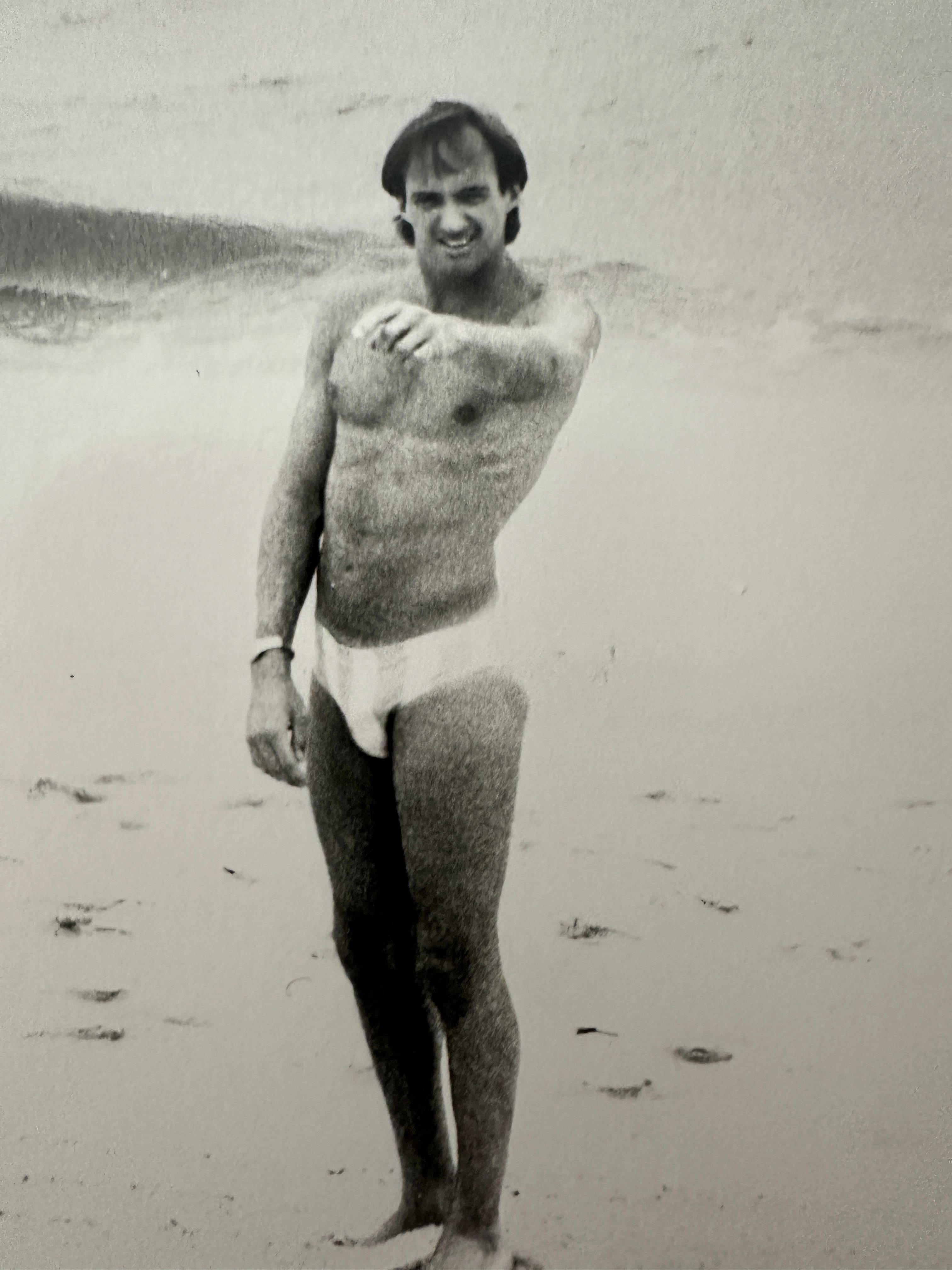 Jon Gould Pointing on Fire Island Beach - Gray Black and White Photograph by Andy Warhol