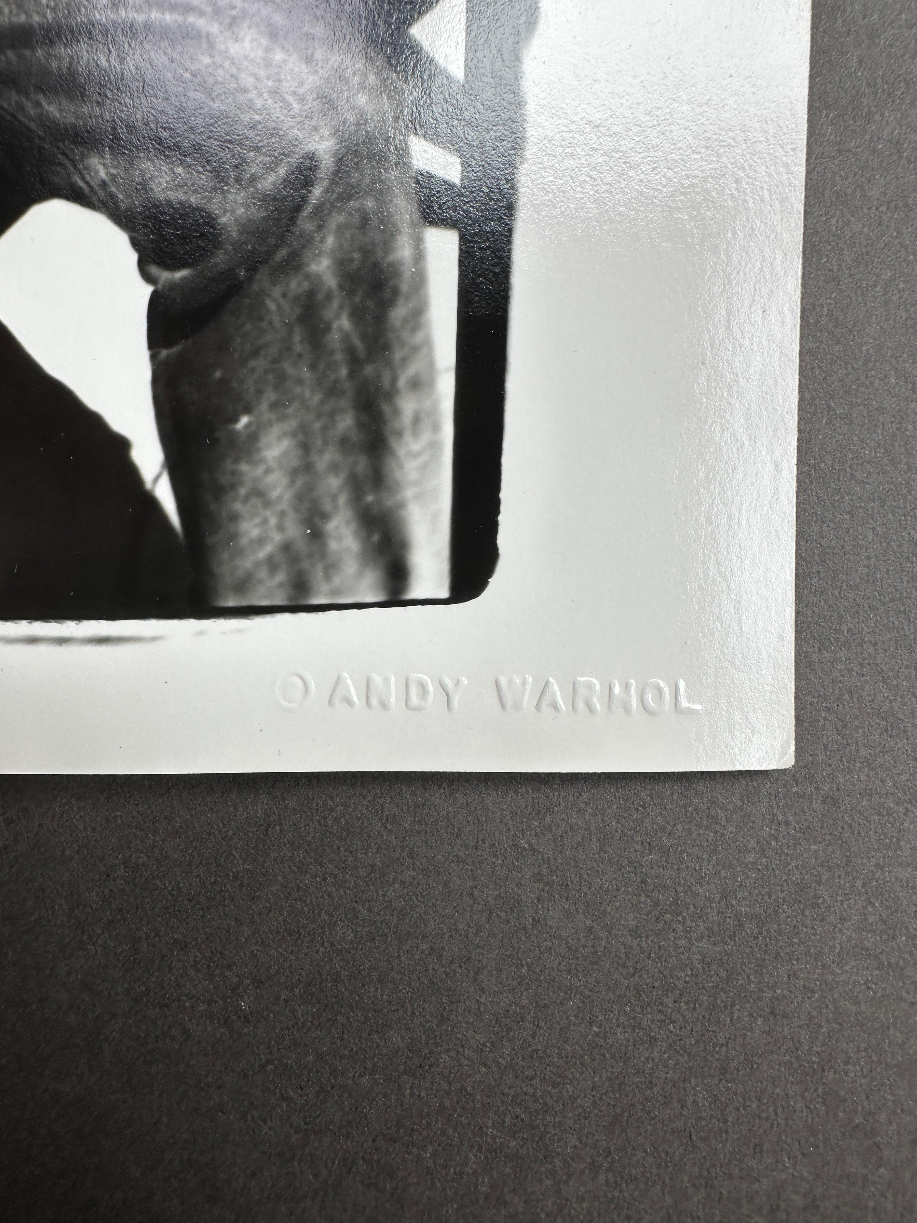 Jon Gould Sunbathing Shirtless with Jeans Seated in Cape Cod - Gray Black and White Photograph by Andy Warhol