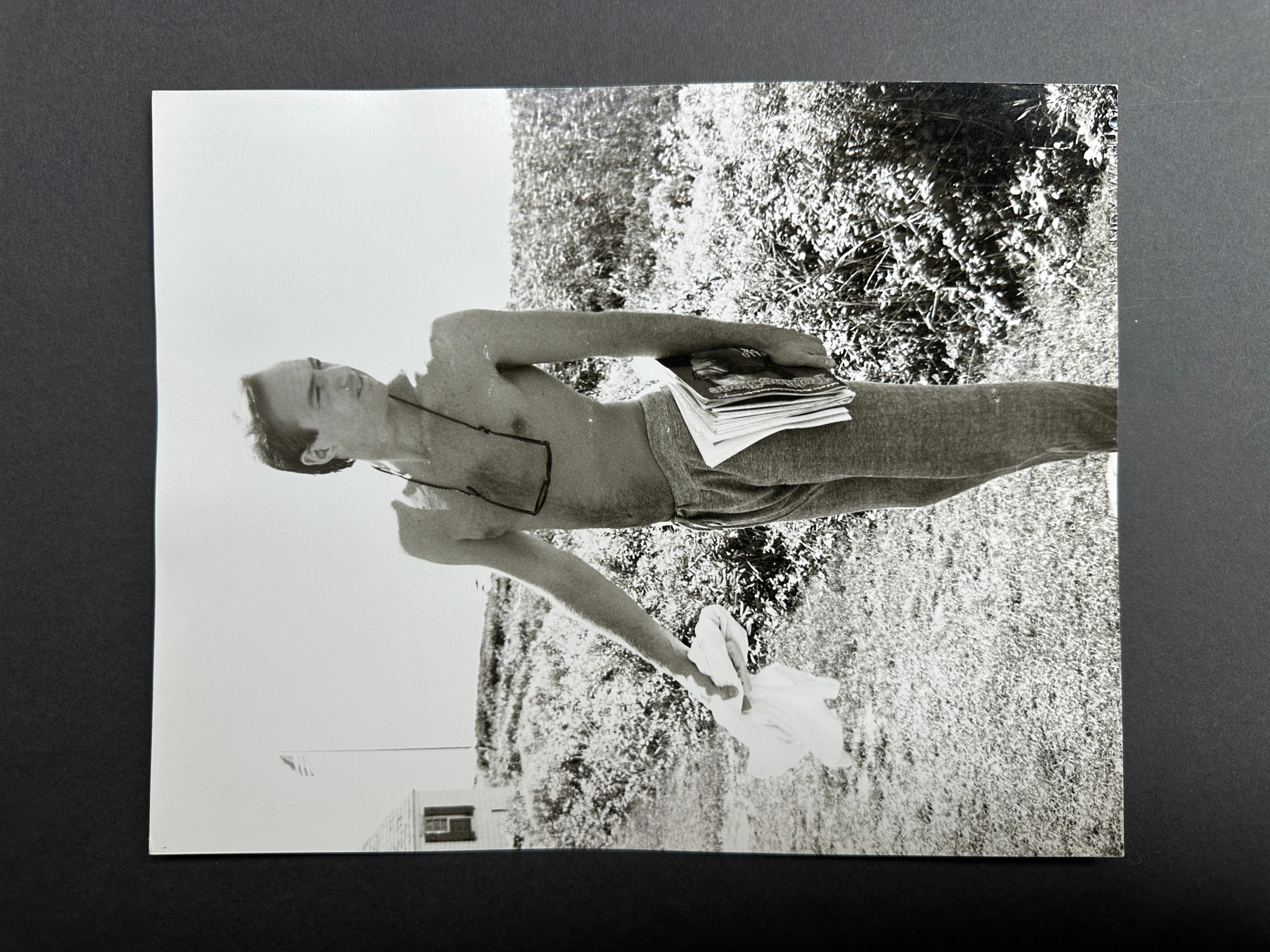 Jon Gould with Magazines in Montauk - Photograph by Andy Warhol
