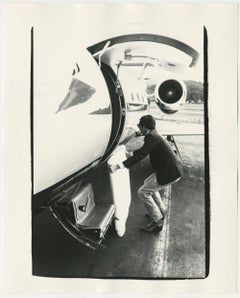 Fred Hughes loading a Warhol painting onto a Learjet 35