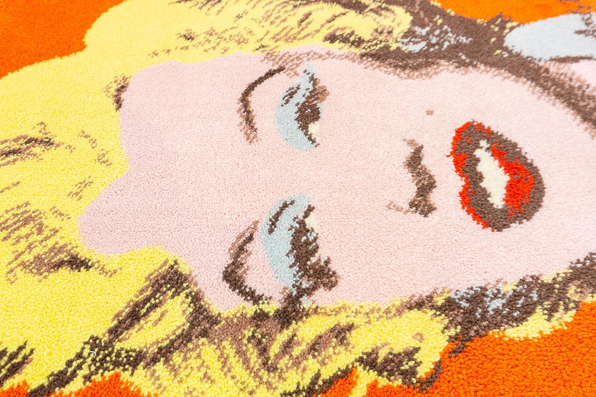 This Andy Warhol-inspired carpet featuring the iconic image of Marilyn Monroe is a vibrant and distinctive piece that captures the essence of Pop Art. Measuring 88 × 71 cm (2' 10