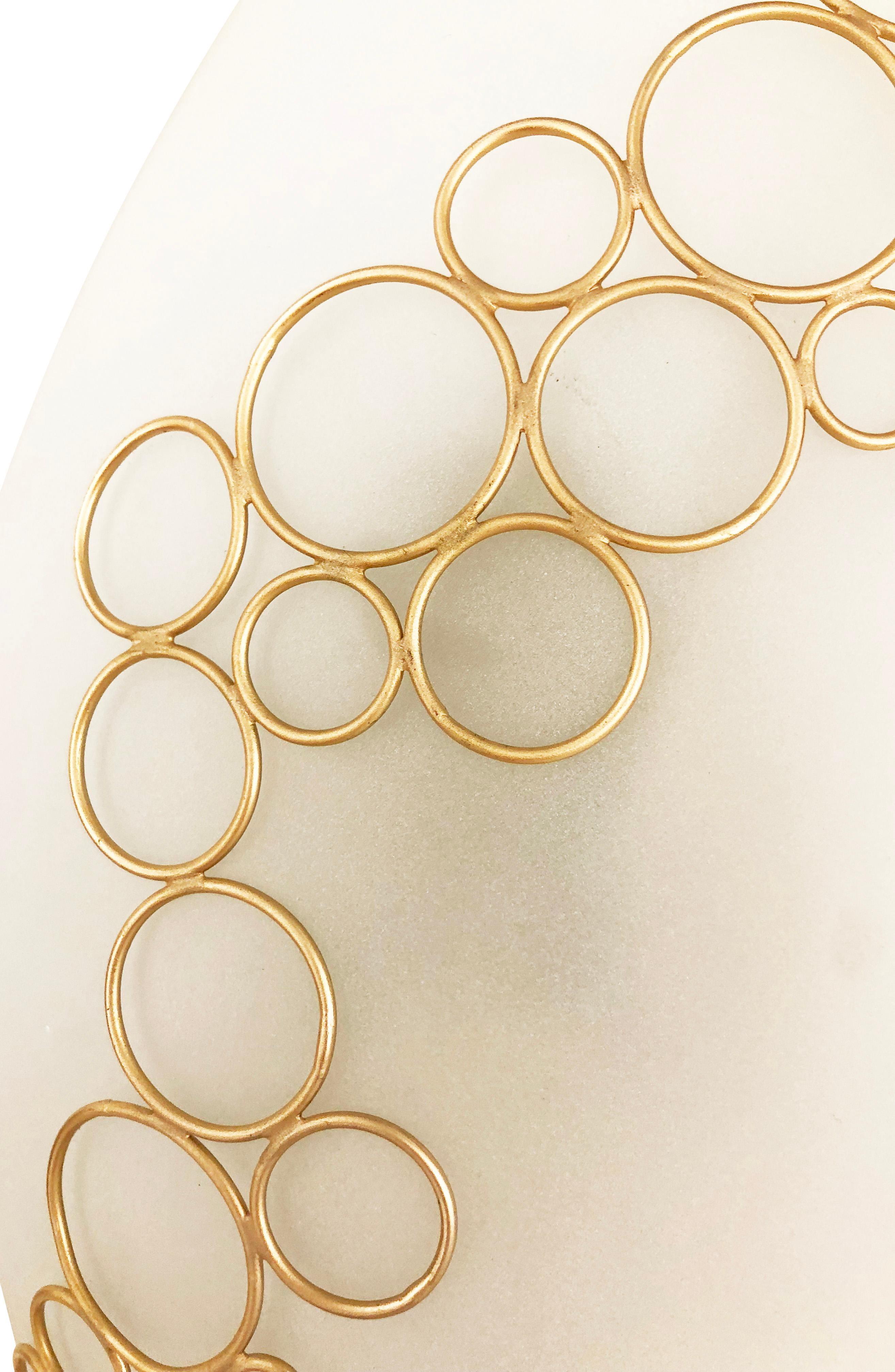 Anelli wall light designed by Gaspare Asaro for his studio collection, formA. Each handmade piece features a white frosted glass decorated with a web of interconnected brass rings. Finish of the brass rings can be customized as needed. Available as