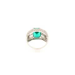 White gold band ring with brilliants ct.1.54 and emerald ct.2.90
