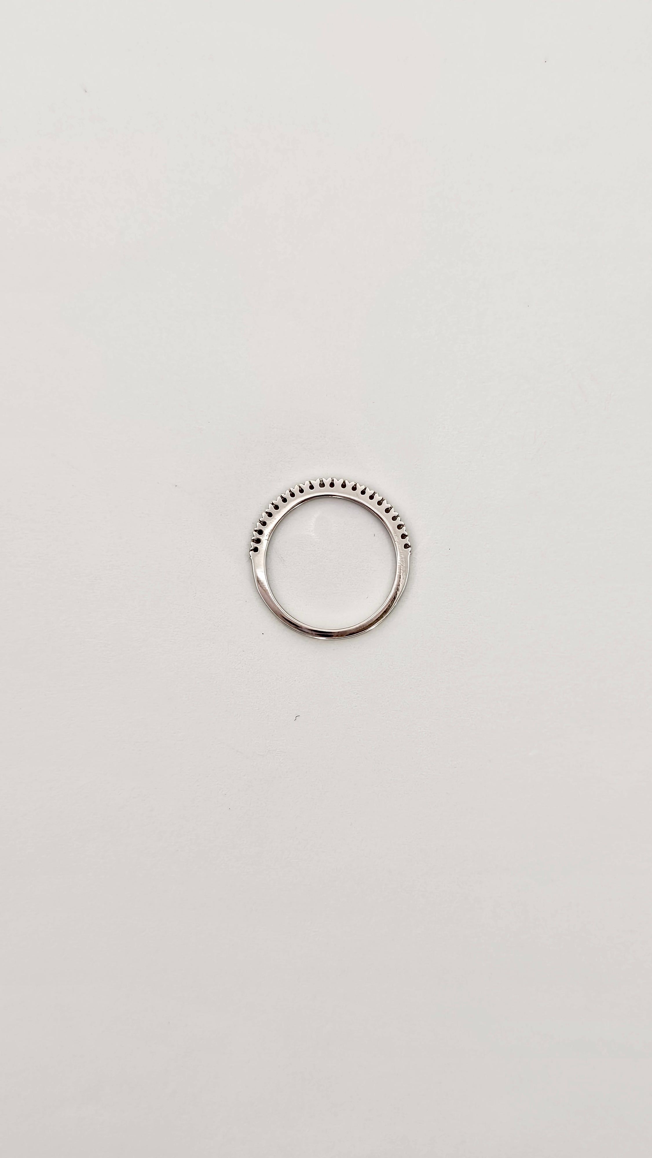 A refined and elegant band ring made of 18kt white gold and brilliant-cut Diamonds.
This ring lends itself to being worn alone or paired with other rings as the stones are set slightly raised.
This particularity causes the Diamonds to receive and