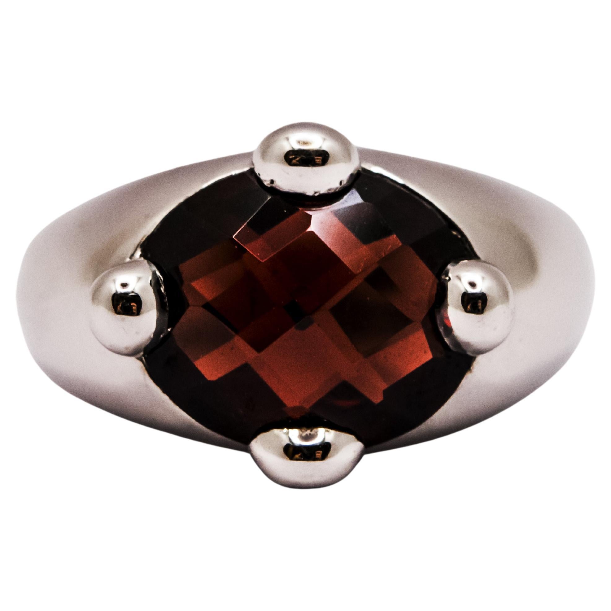 18 Kt White Gold and Faceted Oval Garnet Ring