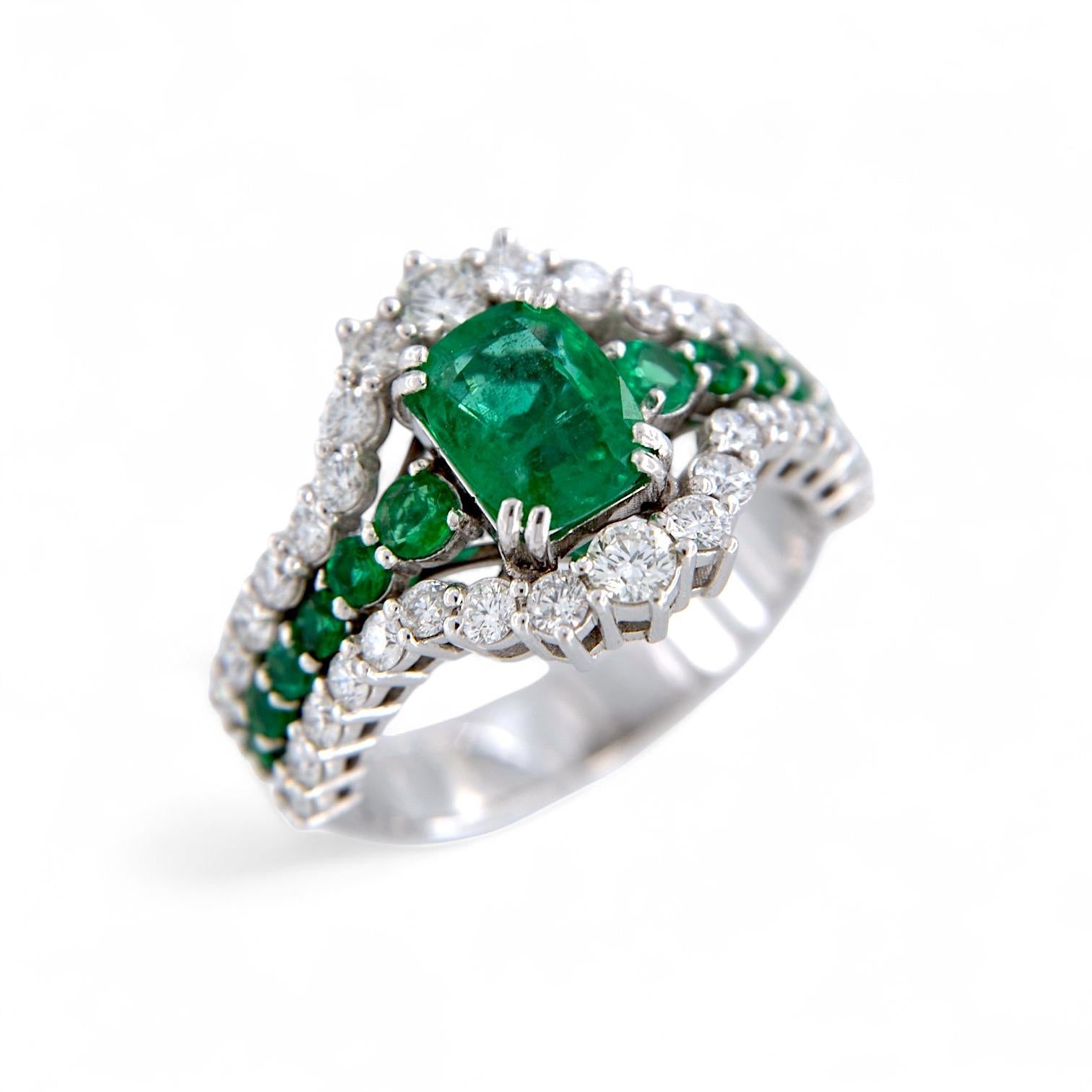 Artisan 18kt white gold ring with 1.53 Ct Emerald, and with Emeralds and Diamonds For Sale