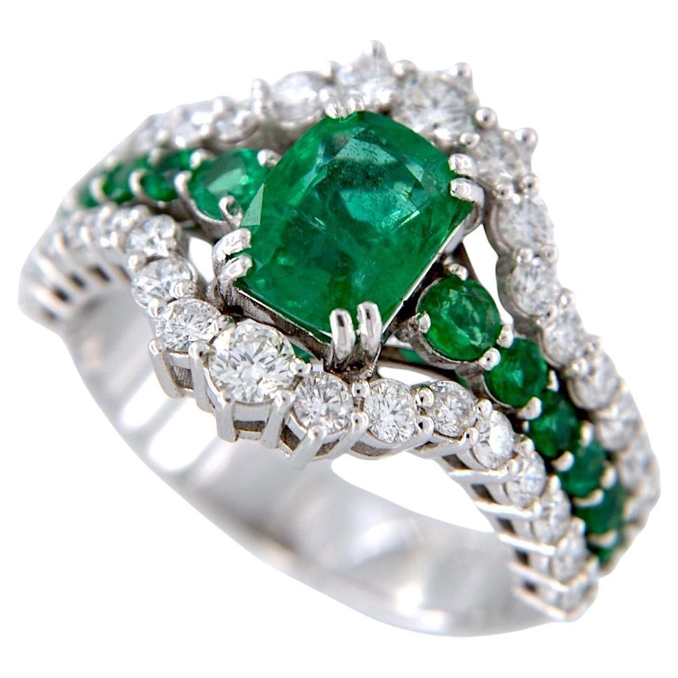 18kt white gold ring with 1.53 Ct Emerald, and with Emeralds and Diamonds For Sale