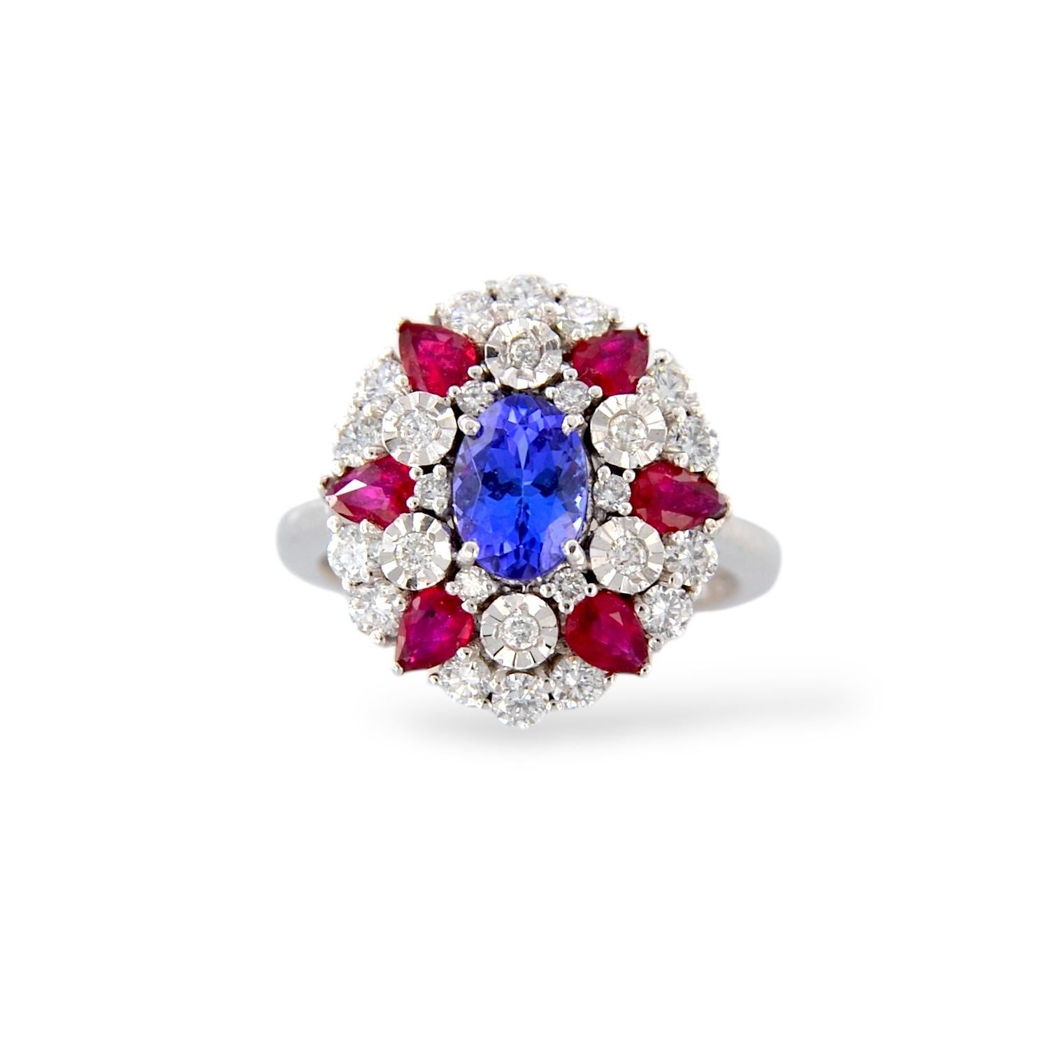 Elegant and full of charm, this white gold ring is a masterpiece of style and sophistication. A stunning 1.05-carat oval tanzanite sparkles in the center, wrapped with six pear-cut rubies totaling 0.83 carats, giving the jewel a vibrant and precious