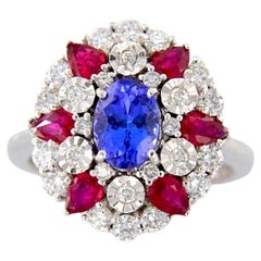 White gold ring with 1.05 ct oval tanzanite, with rubies and diamonds