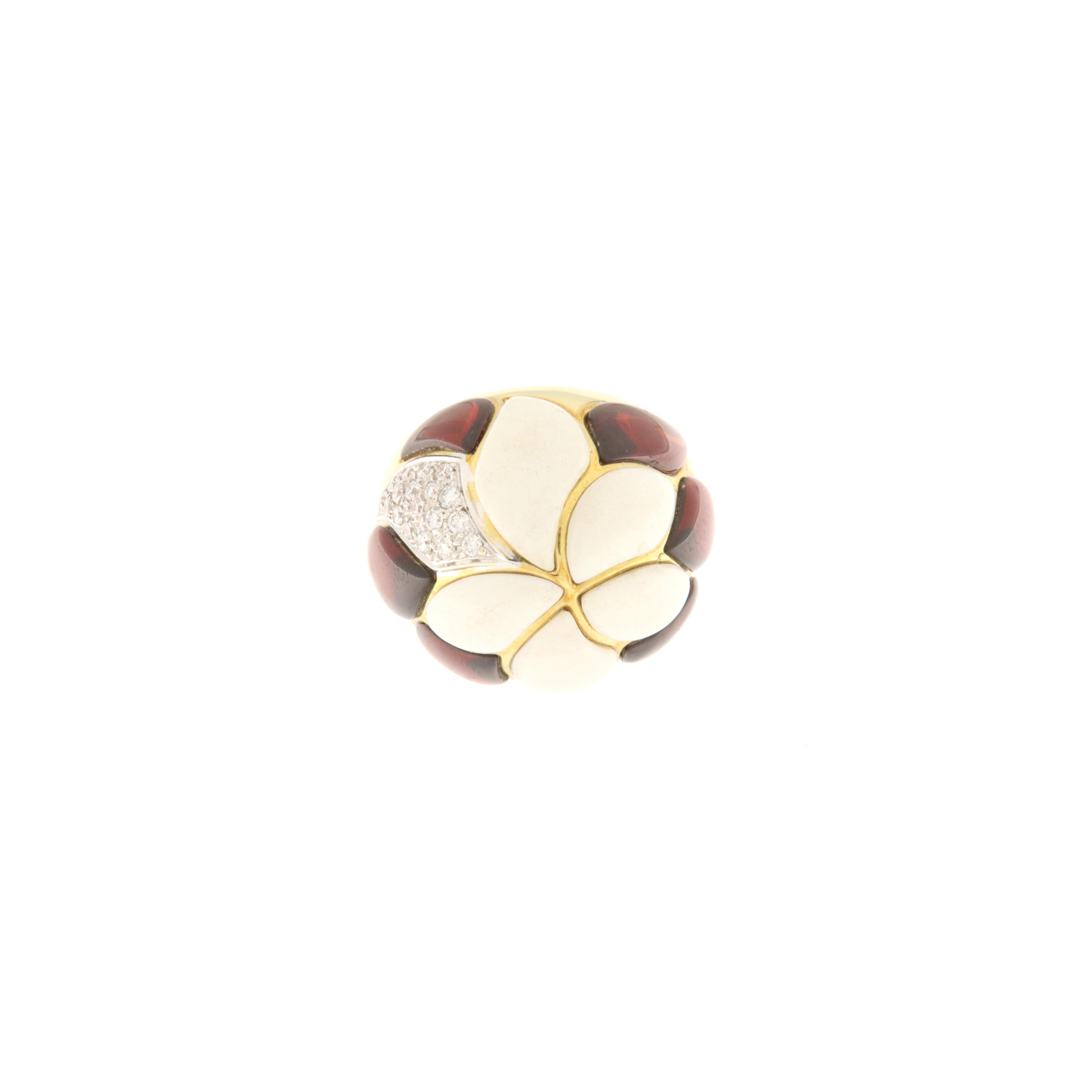 One-of-a-kind ring made of 18 kt gold, with petal decoration made of custom-cut elements of white coral and garnets set together with a single petal of brilliants (ct.0.32). The ring's distinctive design and plastic structure make it a work of fine