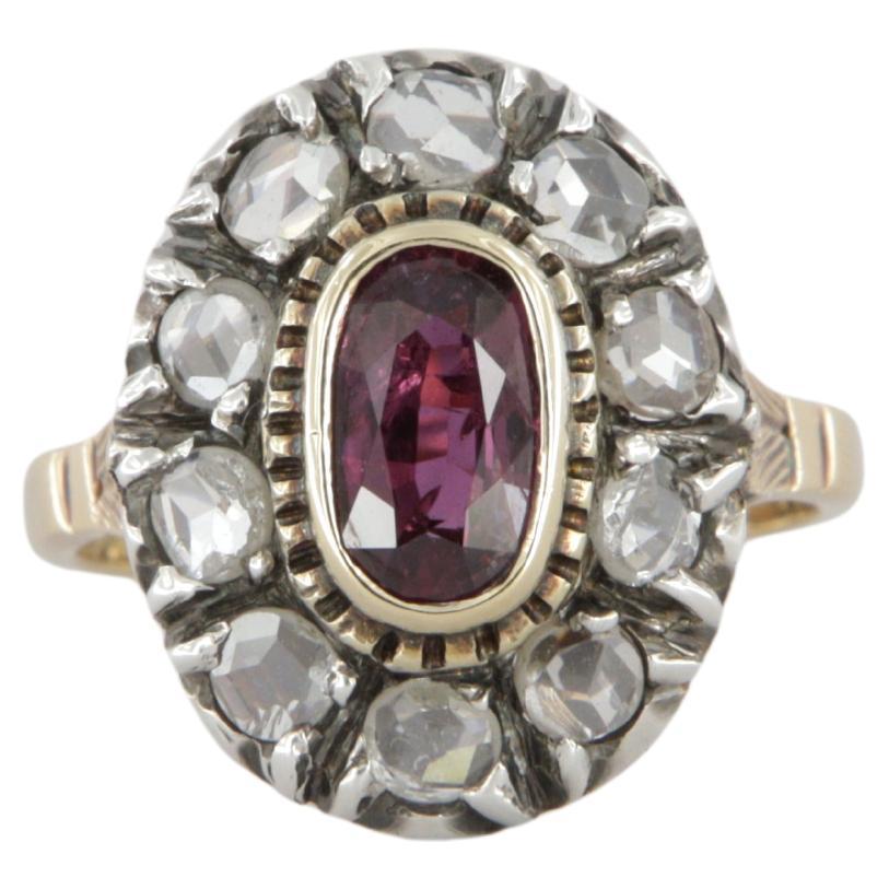 Anillo estilo antiguo en oro y plata con diamantes y un rubí ovalado ct 0.95