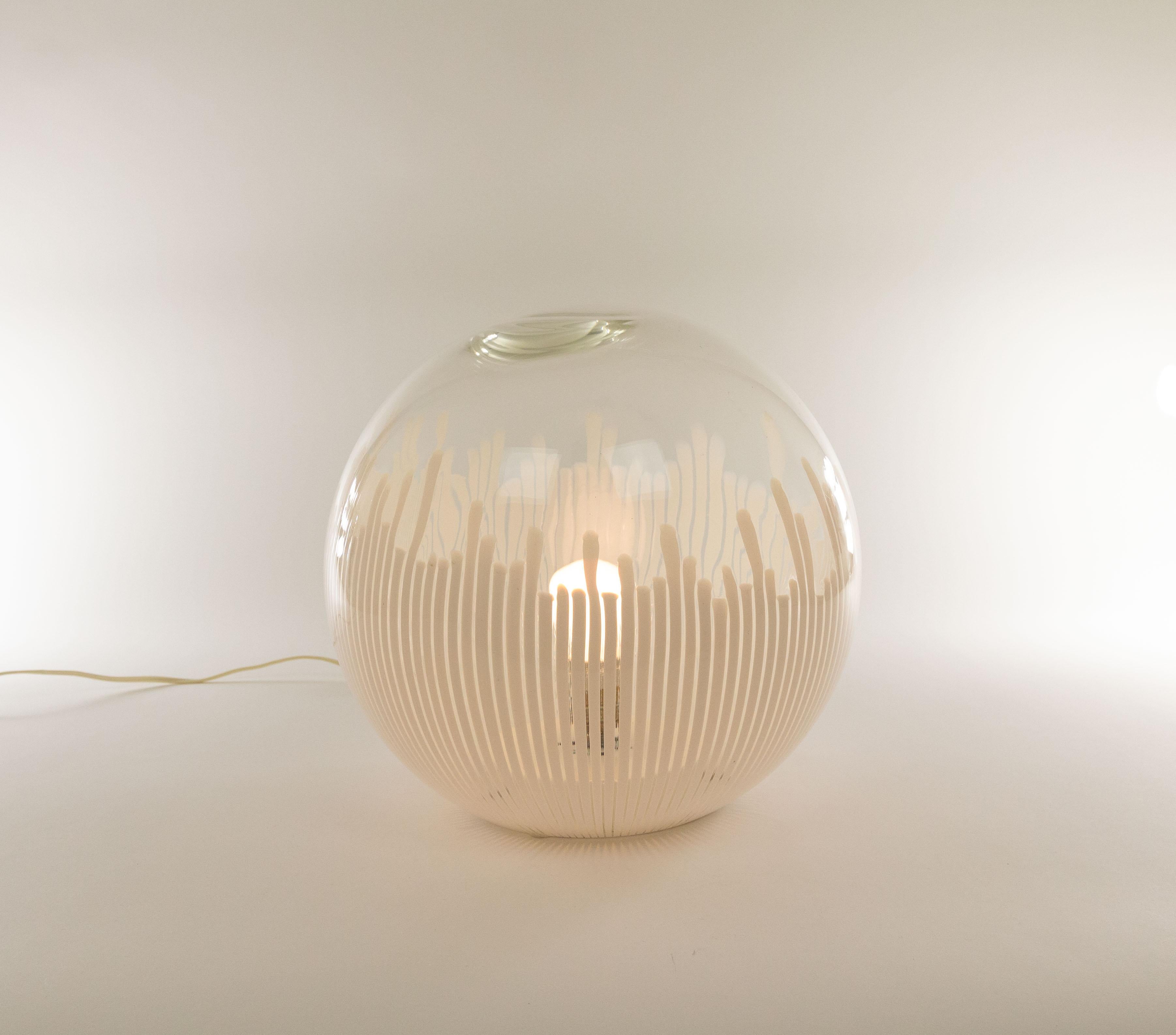 Anemone hand-blown glass table lamp designed by Ludovico Diaz de Santillana for Murano glass specialist Venini in the 1970s.

The elegant model that seems to have been inspired by sea anemones was originally executed in white, amber and green. The