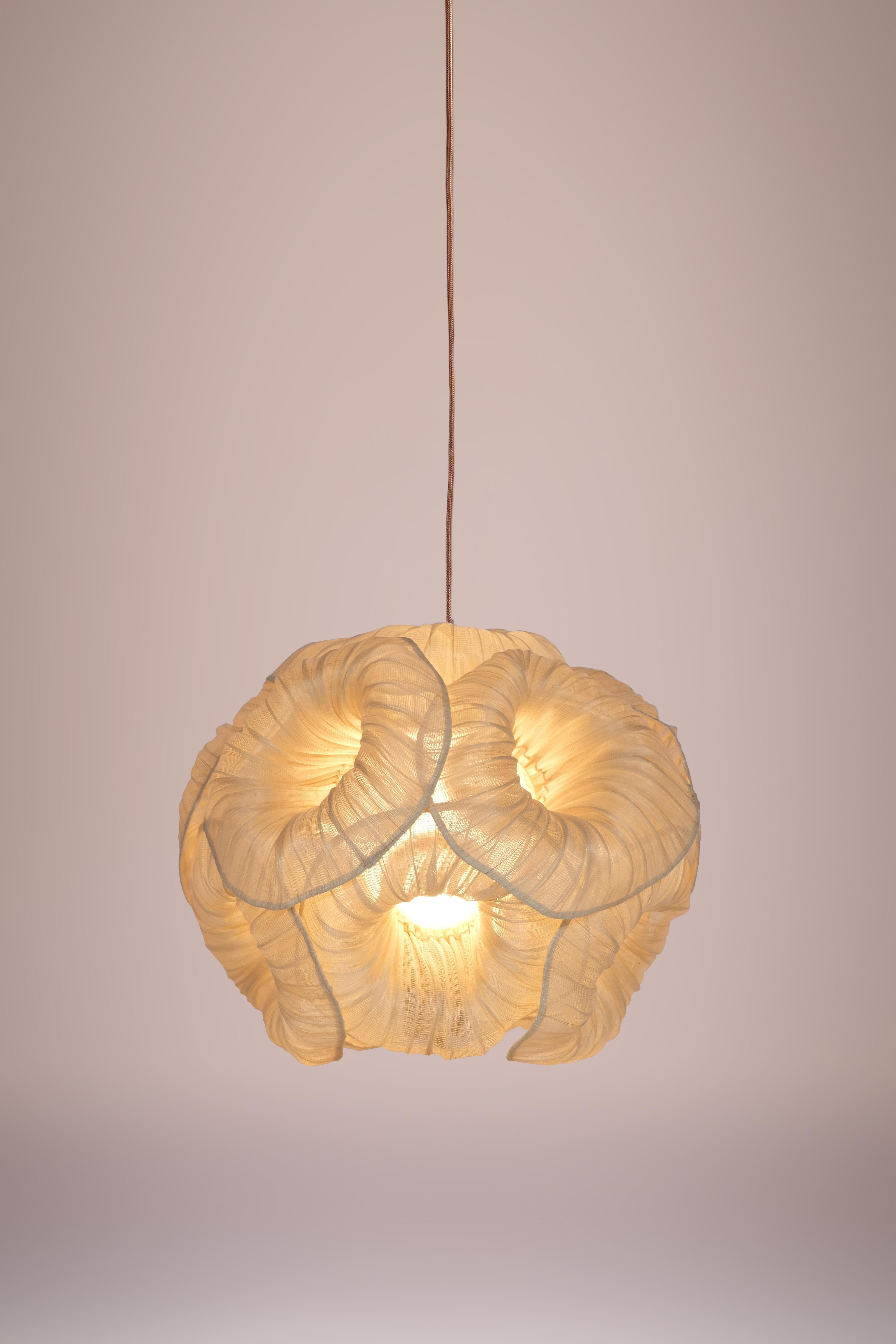 Anemone pendant lamp by Mirei Monticelli
Dimensions: D 35 cm
Materials: Banaca fabric
Also available in hand-painted fabric.

The simple elegance of the Anemone Pendant Lamp provides an eye-catching aesthetic in any home while diffusing ambient