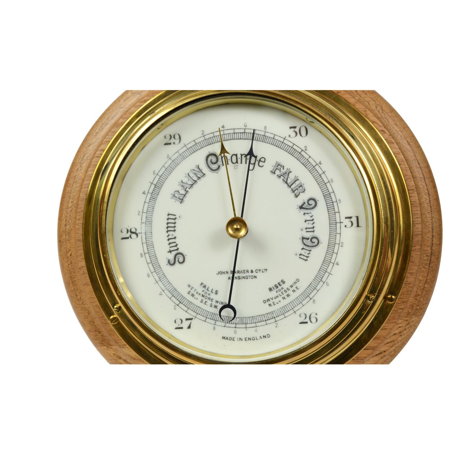 Aneroid barometer made of brass-mounted on a turned wooden plank, with scale of white opaline, signed John Barker & Co Ltd Kensington, made in the early 1900. Very good condition and working perfectly. Diameter plank included 28 cm, height 10