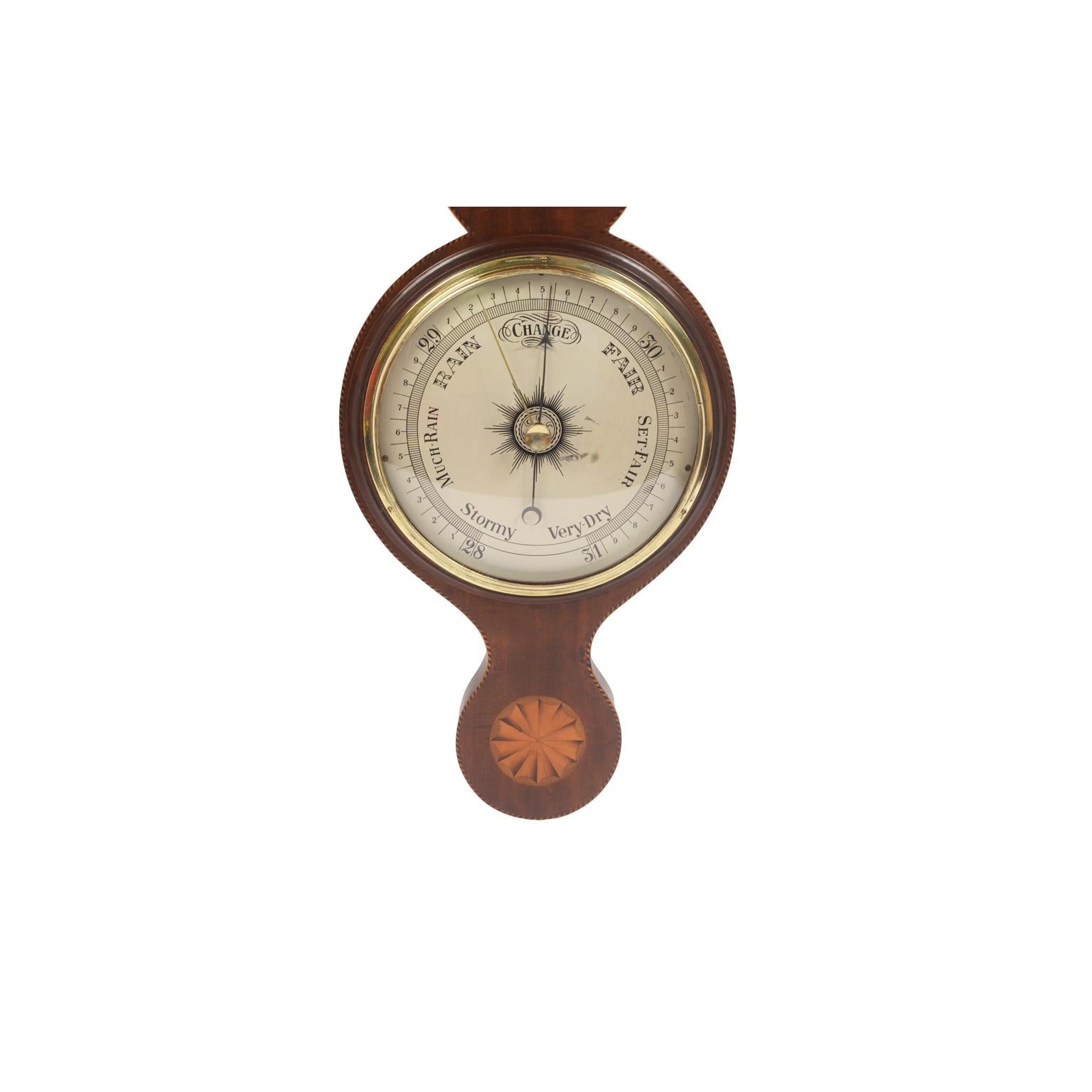 Aneroid barometer of mahogany with threads and decorative motifs. Silver-plated brass dial engraved with meteorological indications and double hand, the first one directly connected to the barometric box indicates the atmospheric pressure trend, the