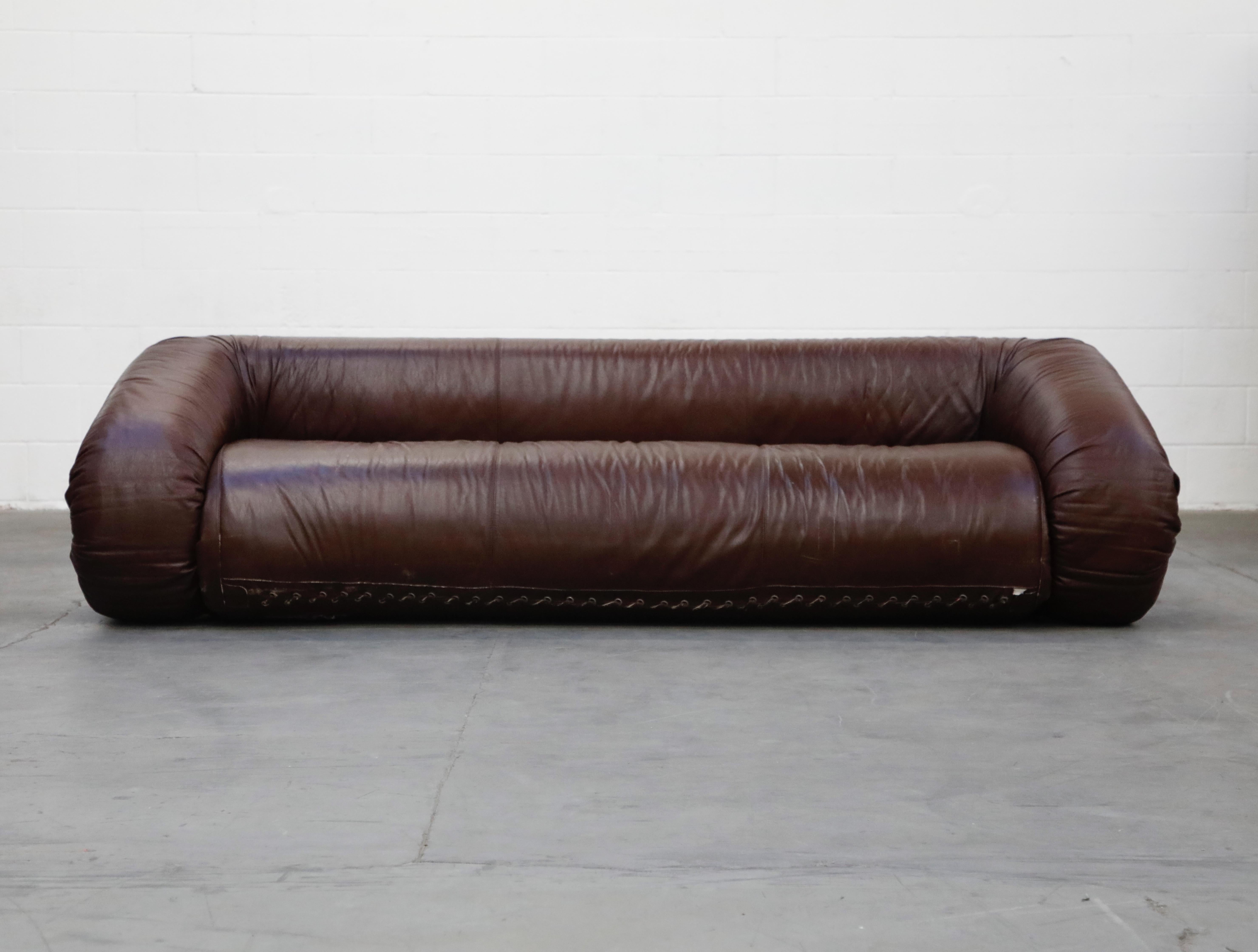 This incredibly coveted and sought after 'Anfibio' convertible sofa bed is by Alessandro Becchi for Giovanetti, designed and produced in the early 1970s, featuring incredibly luscious deep brown leather which has a slight warm tone that gives