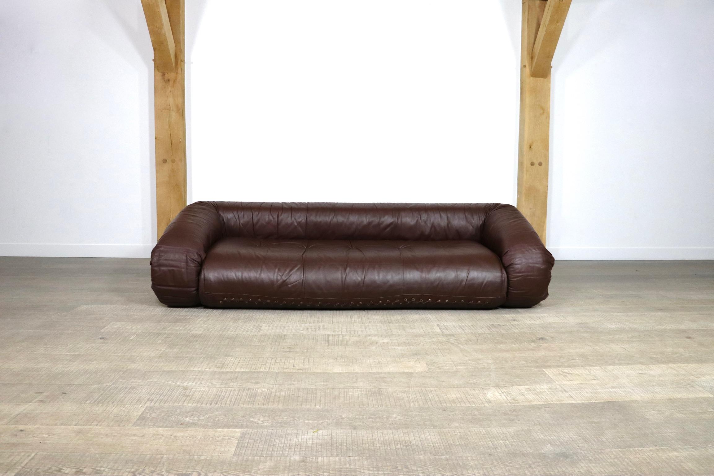 Incredible Anfibio sofa bed by Alessandro Becchi for Giovanetti Collezione Italy 1971. This stunning original brown leather upholstery fits perfectly with the white teddy fabric on the mattress inside. The sofa can easily be converted into a bed, or