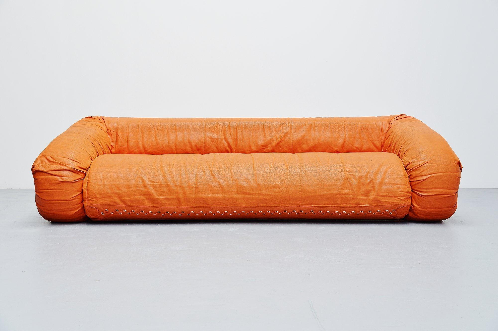 Very nice multi functional 'Anfibio' bed sofa designed by Alessandro Becchi and manufactured by Giovanetti, Italy 1971. This sofa is in orange faux leather and seats super comfortable. The sofa can be easily turned into a bed or play mattress for