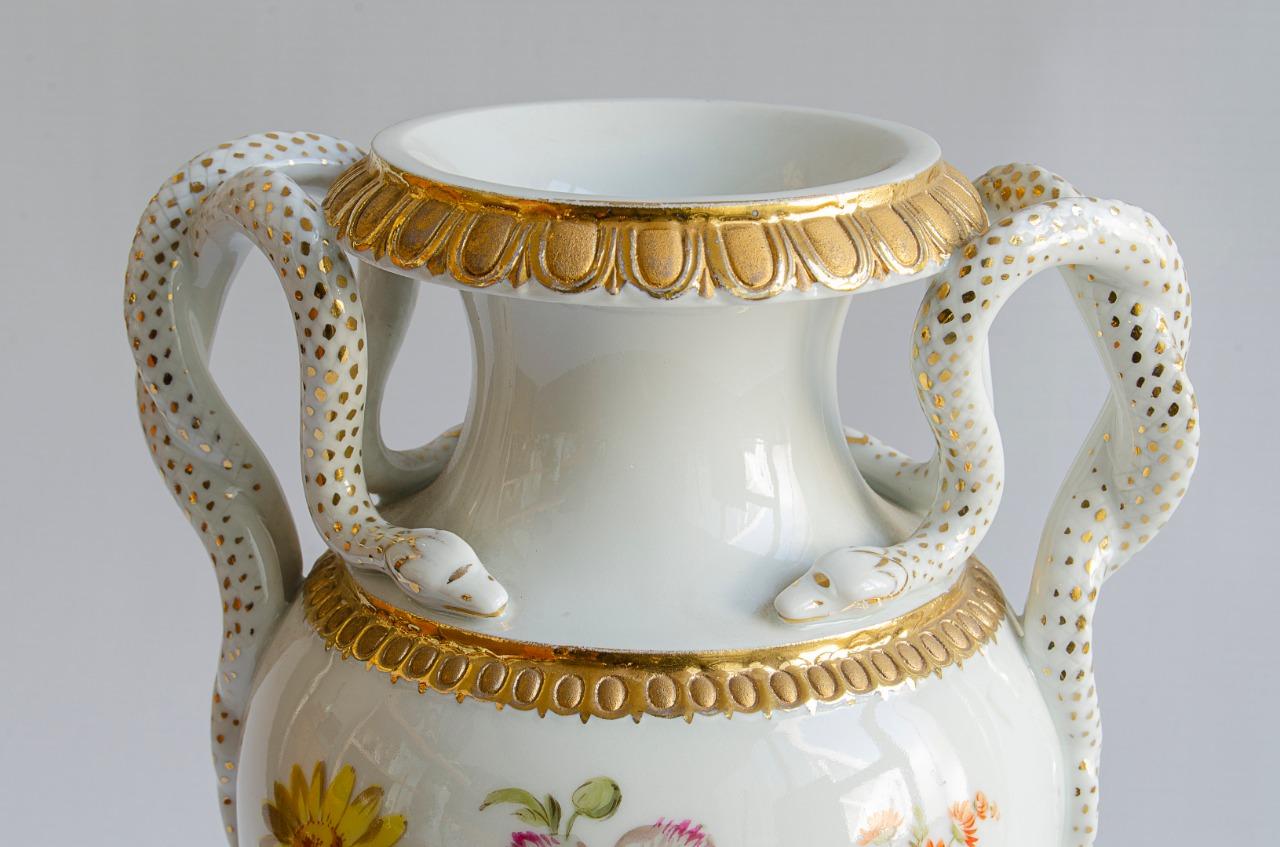 Anfora Meissen porcelain material
the handles are with snake motif
the body is rotatable and has painted floral motifs
Origin Germany circa 1900.