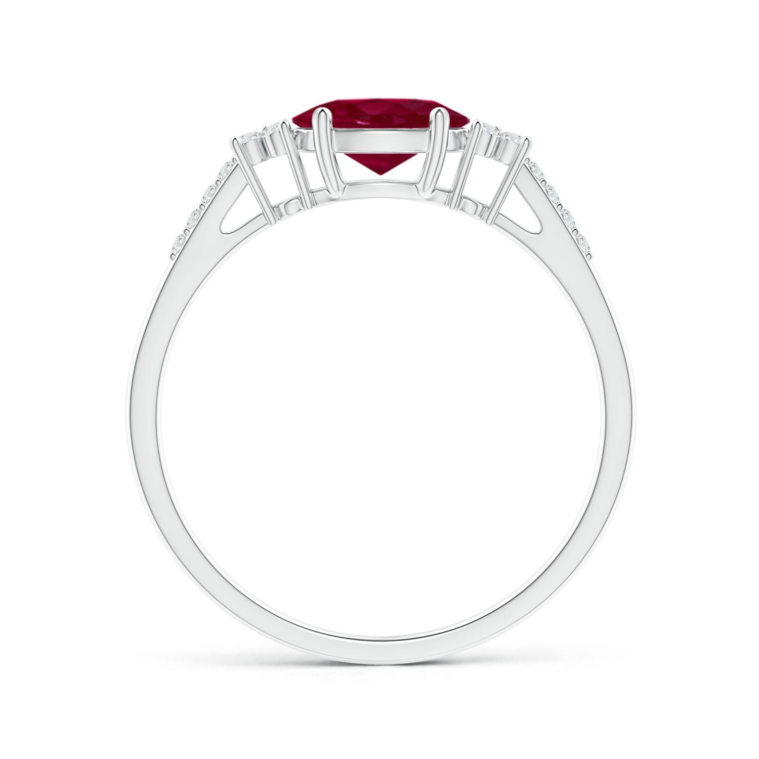 Horizontally secured at the center of this gorgeous solitaire ring is an oval ruby. Trios of shimmering diamonds flank the brilliant center stone, and additional diamond accents adorn the shoulders. The ruby and the diamonds in this platinum east