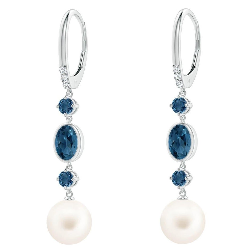 Pendientes de perlas cultivadas de agua dulce Angara con topacios azules de Londres en oro de 14 quilates