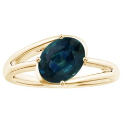 Angara Gia Certified Natural Solitaire Teal Sapphire Bypass Ring in Yellow Gold