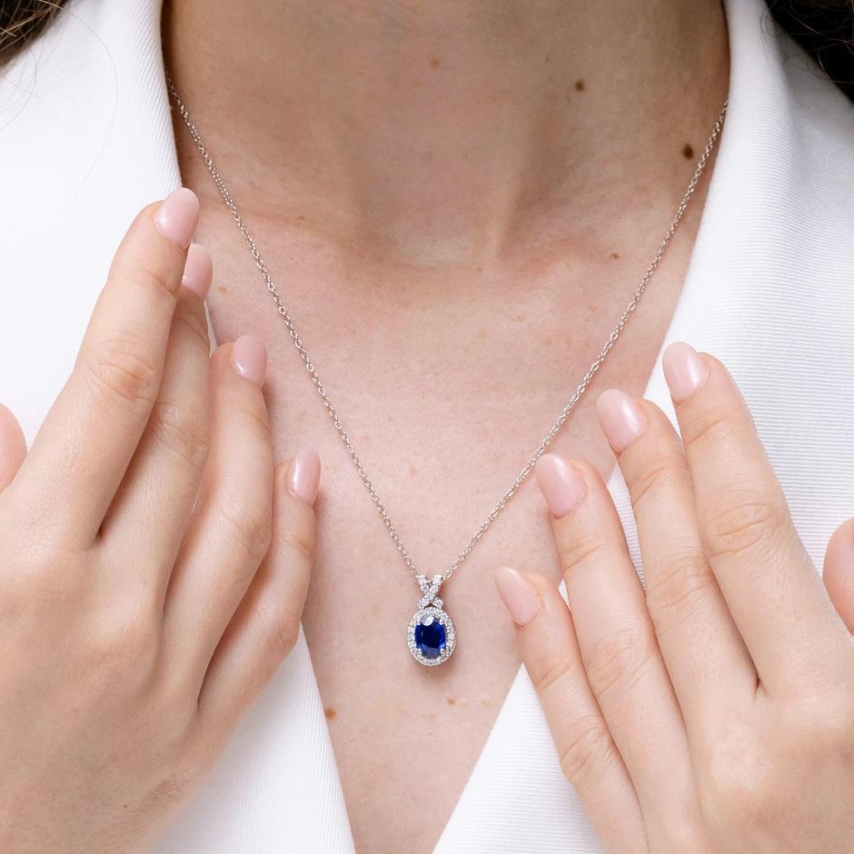 Oval Cut ANGARA Natural 0.60ct Blue Sapphire Pendant with Diamond Halo in 14K White Gold For Sale