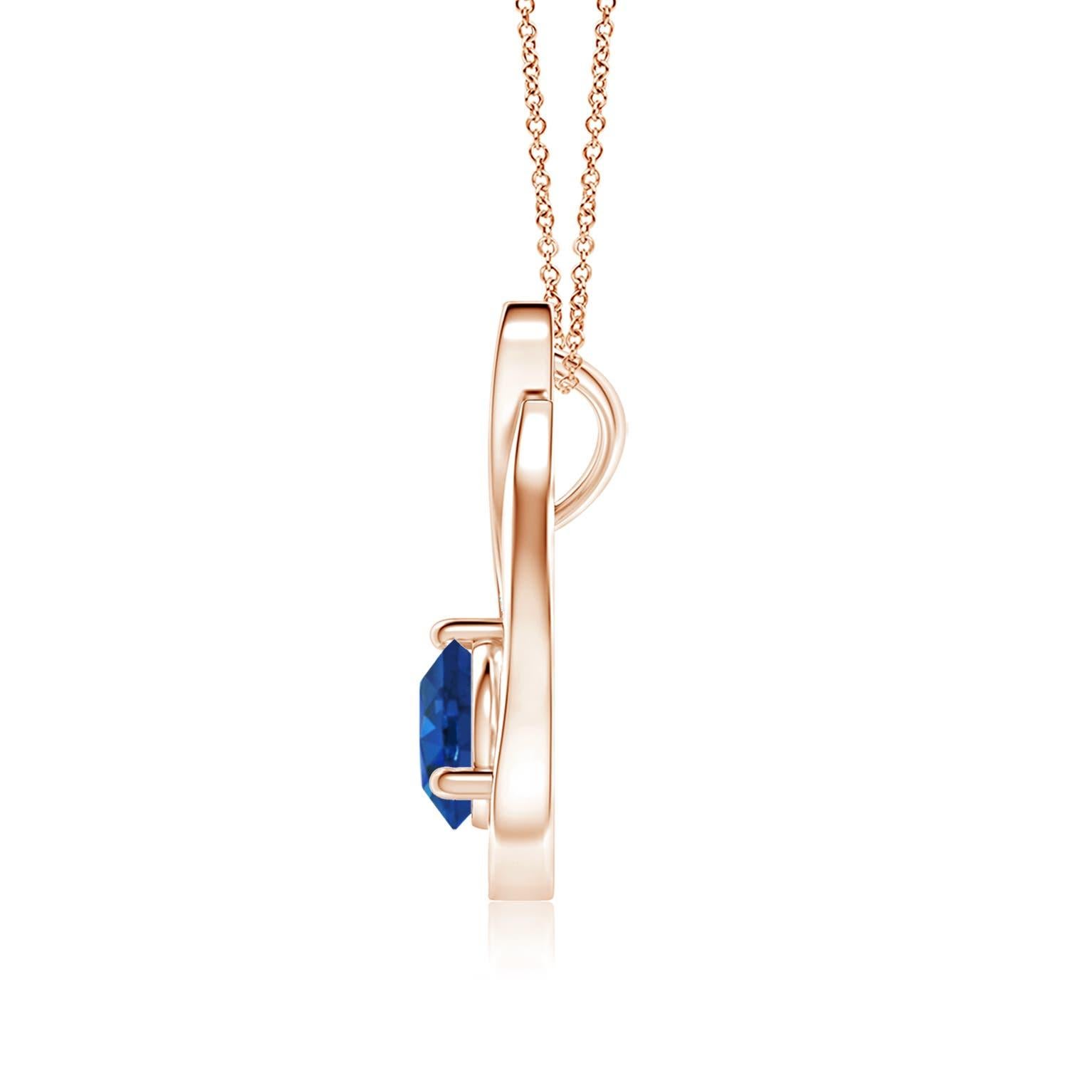 Un ciondolo a tulipano in oro rosa 14k con uno zaffiro blu che ti ipnotizzerà con il suo splendore divino. Il design è caratterizzato da uno zaffiro rotondo incastonato e da accenti di diamanti che completano splendidamente lo scintillio della