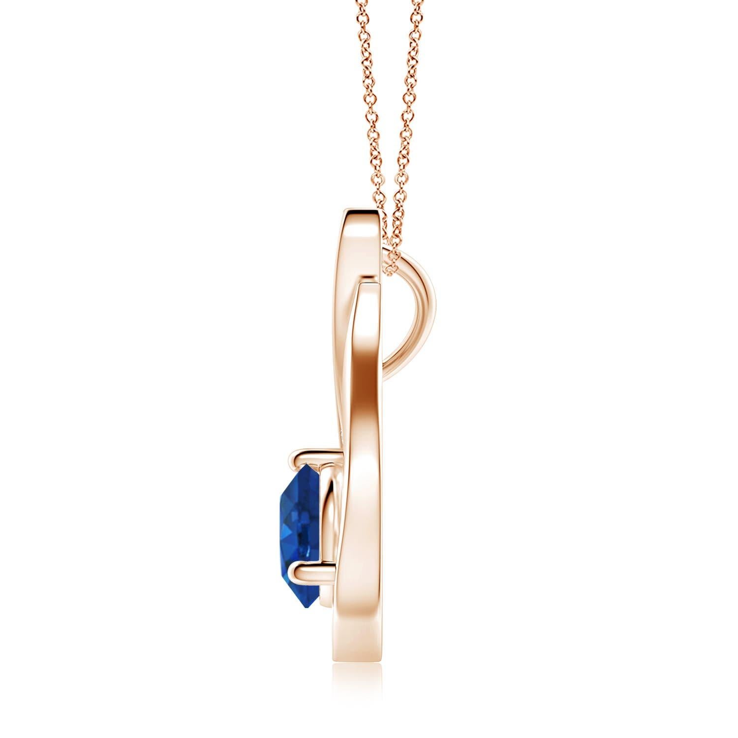 Pendentif tulipe en or rose 14 carats orné d'un saphir bleu qui vous envoûtera par son éclat divin. Le modèle présente un saphir rond serti sur un anneau et des accents de diamant qui complètent magnifiquement l'éclat de la pierre précieuse,