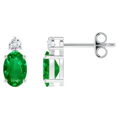 Angara - Boucles d'oreilles en or 14 carats avec émeraude ovale sertie d'un panier et d'un diamant