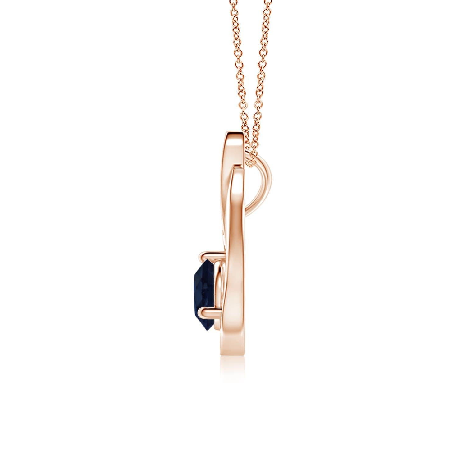 Un ciondolo a tulipano in oro rosa 14k con uno zaffiro blu che ti ipnotizzerà con il suo splendore divino. Il design è caratterizzato da uno zaffiro rotondo incastonato e da accenti di diamanti che completano magnificamente lo scintillio della