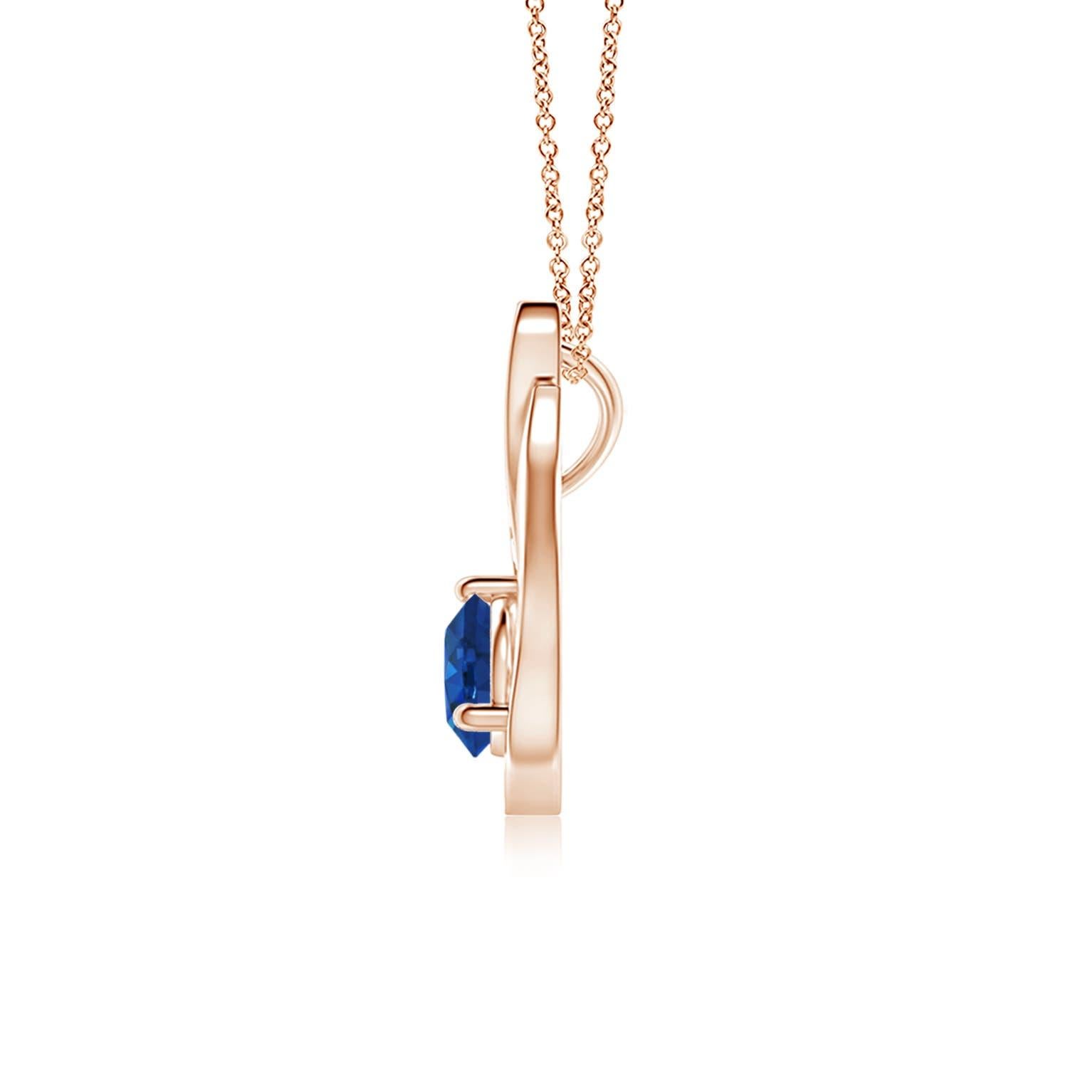 Un ciondolo a tulipano in oro rosa 14k con uno zaffiro blu che ti ipnotizzerà con il suo splendore divino. Il design è caratterizzato da uno zaffiro rotondo incastonato e da accenti di diamanti che completano splendidamente lo scintillio della