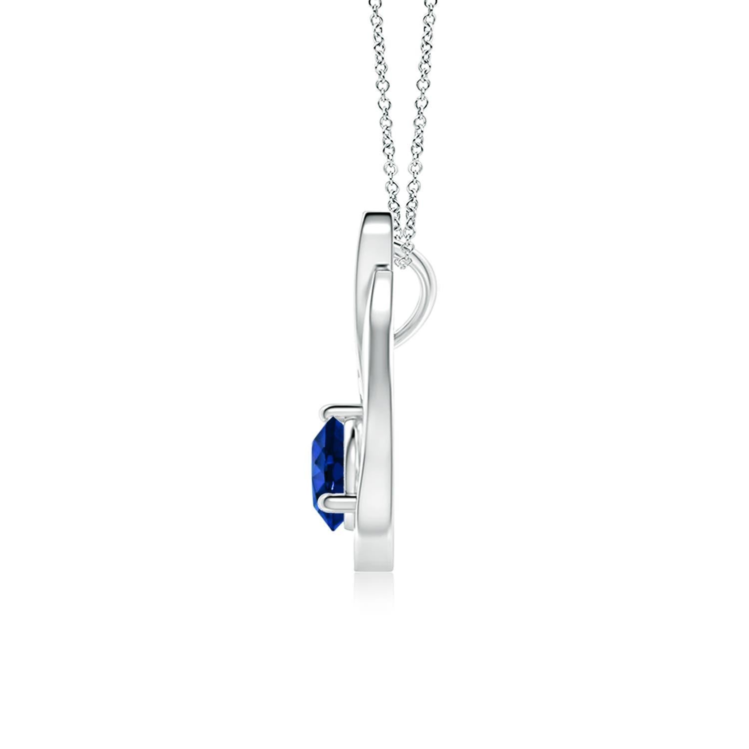 Un pendentif tulipe en platine orné d'un saphir bleu qui vous envoûtera par son éclat divin. Le modèle présente un saphir rond serti sur un anneau et des accents de diamants qui complètent magnifiquement l'éclat de la pierre précieuse, semblable à
