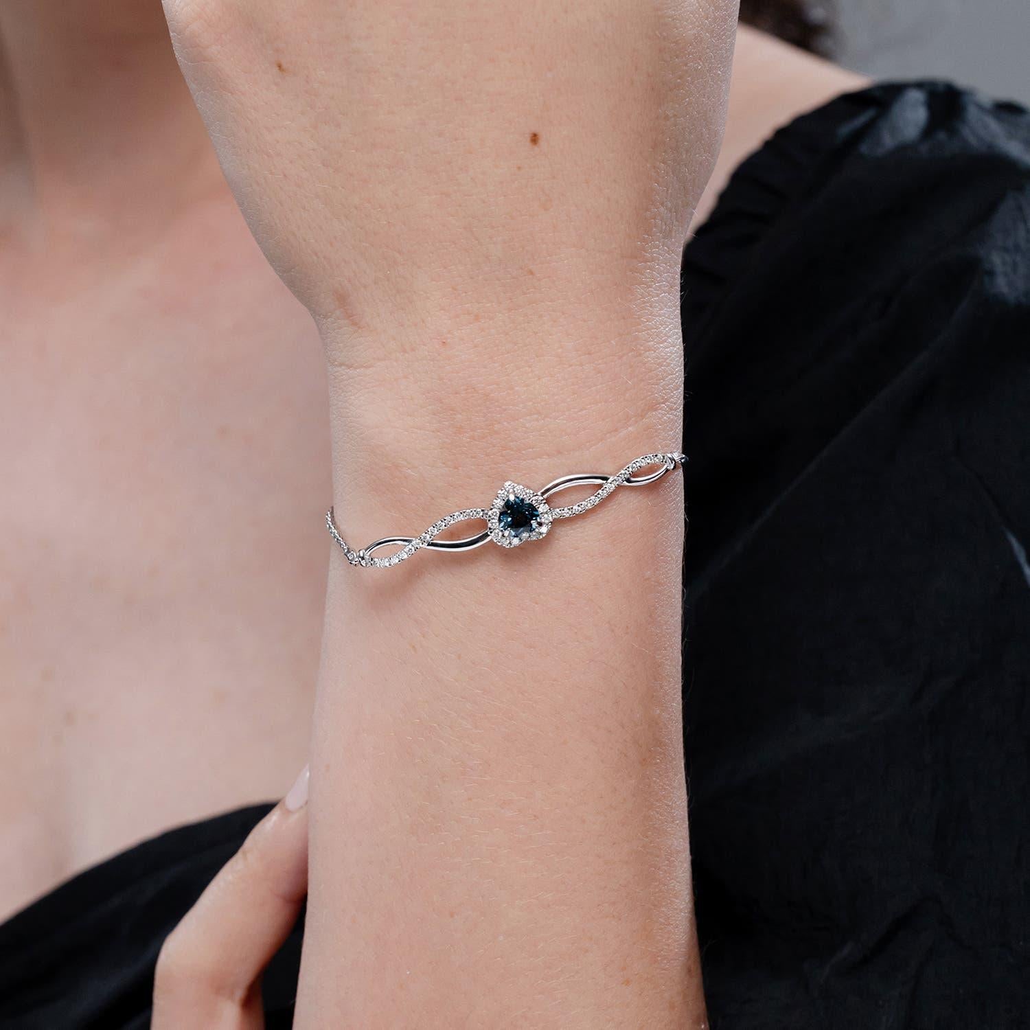 Modern Angara Natural Heart-Shaped London Blue Topaz Infinity Bolo Bracelet in 14K Gold For Sale