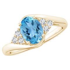 Angara Natural Oval 1.5 ct Swiss Blue Topaz Ring with Diamond in 14K Solid Gold