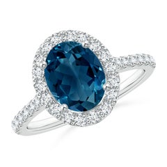 Angara Natürlicher ovaler 2,25 ct Londoner Blautopas Halo-Ring mit Diamant in 14K Gold