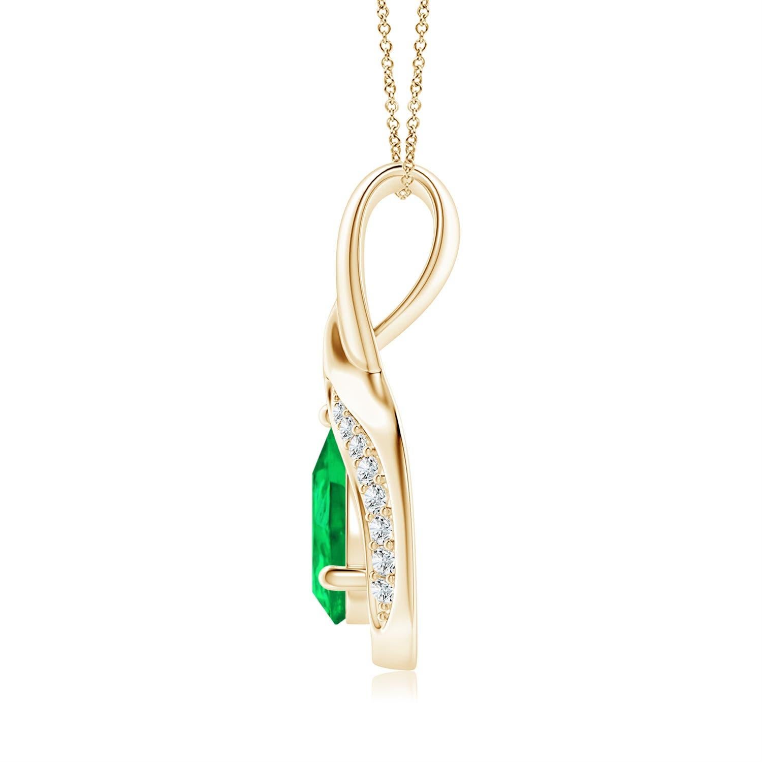 La esmeralda en forma de pera está enmarcada por un precioso lazo de metal brillante en forma de gota. Brillantes diamantes engastados adornan la curva para un borde resplandeciente. Este impresionante colgante de esmeralda y diamante en oro