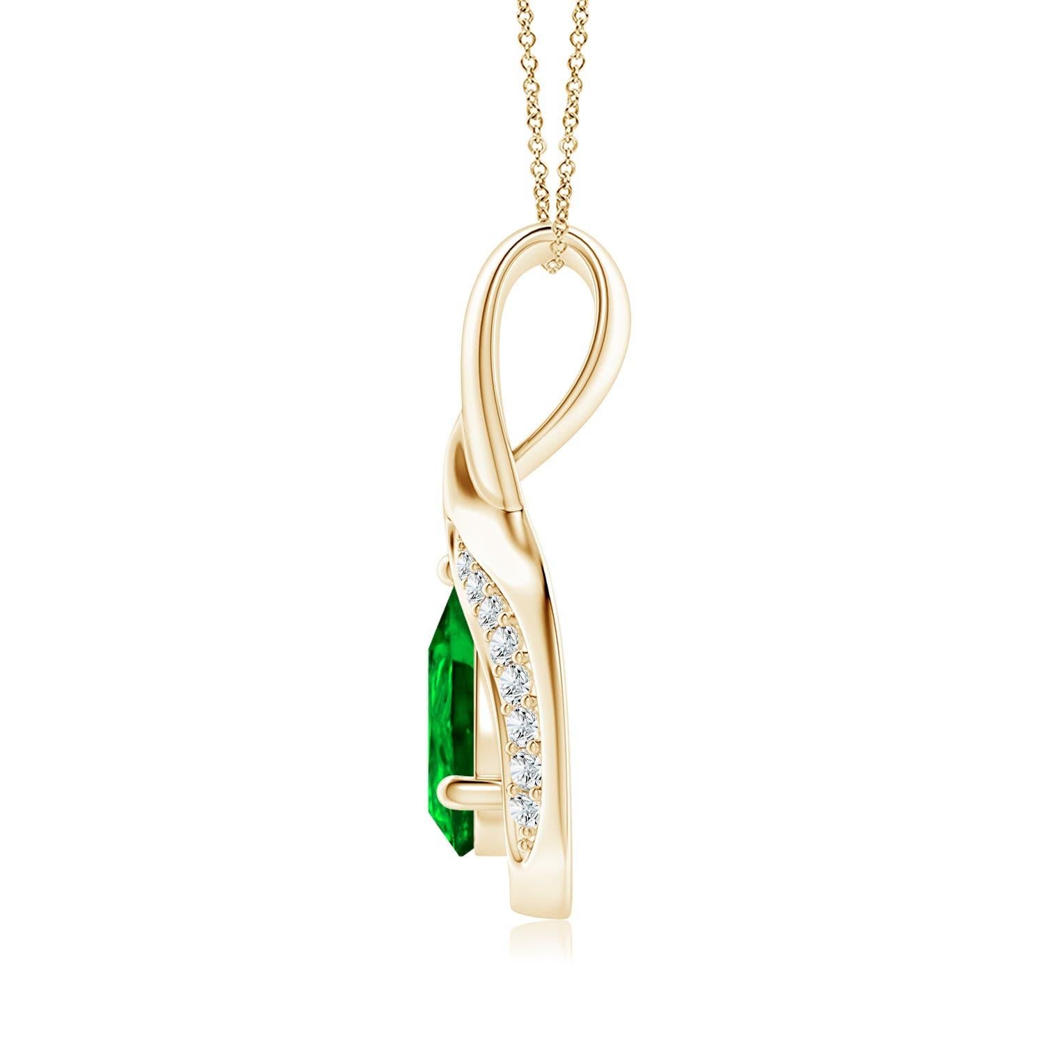 La esmeralda en forma de pera está enmarcada por un precioso lazo de metal brillante en forma de gota. Brillantes diamantes engastados adornan la curva para un borde resplandeciente. Este impresionante colgante de esmeralda y diamante en oro