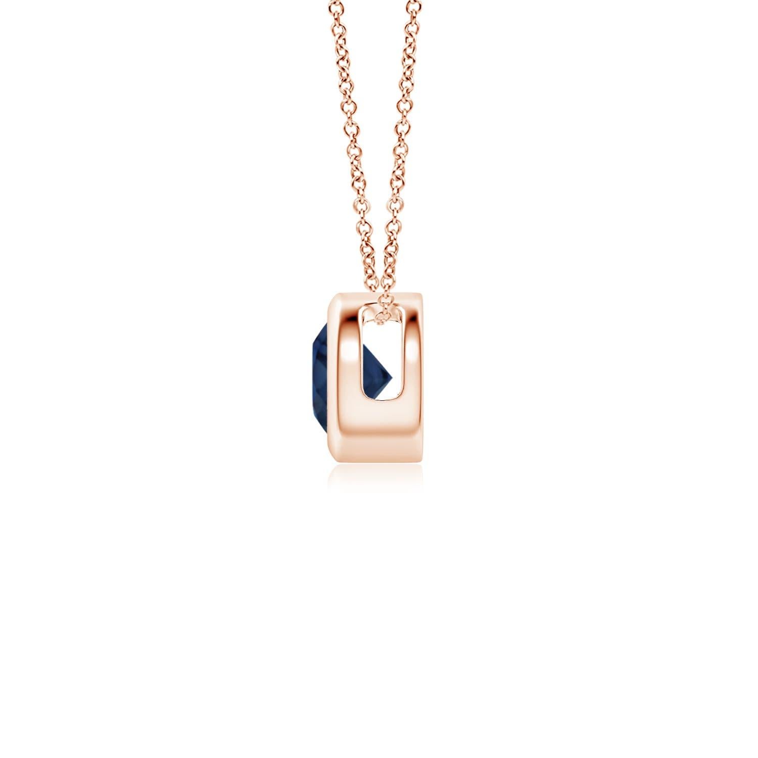 This classic solitaire sapphire pendant's beautiful design makes the center stone appear like it's floating on the chain. The radiant blue gem is secured in a bezel setting. Crafted in 14k rose gold, this round sapphire pendant is simple yet