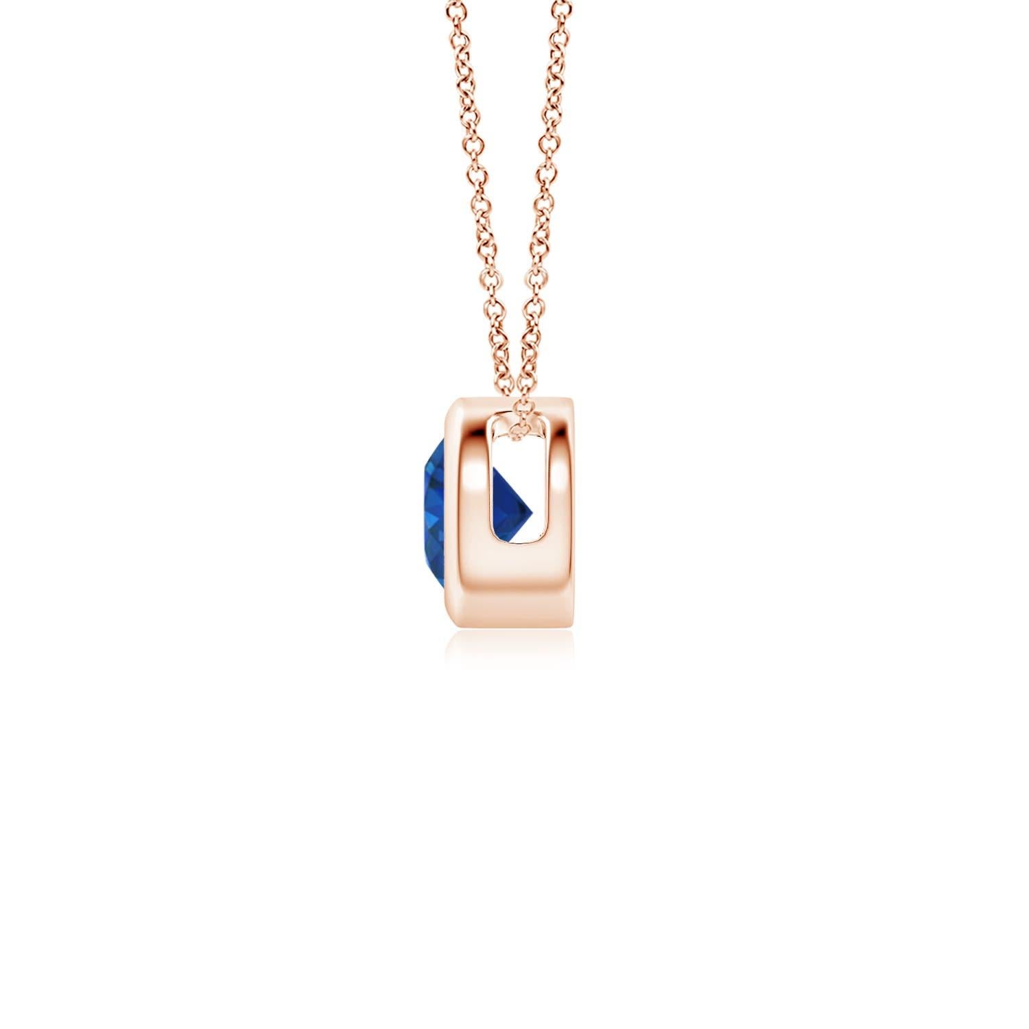 This classic solitaire sapphire pendant's beautiful design makes the center stone appear like it's floating on the chain. The radiant blue gem is secured in a bezel setting. Crafted in 14k rose gold, this round sapphire pendant is simple yet